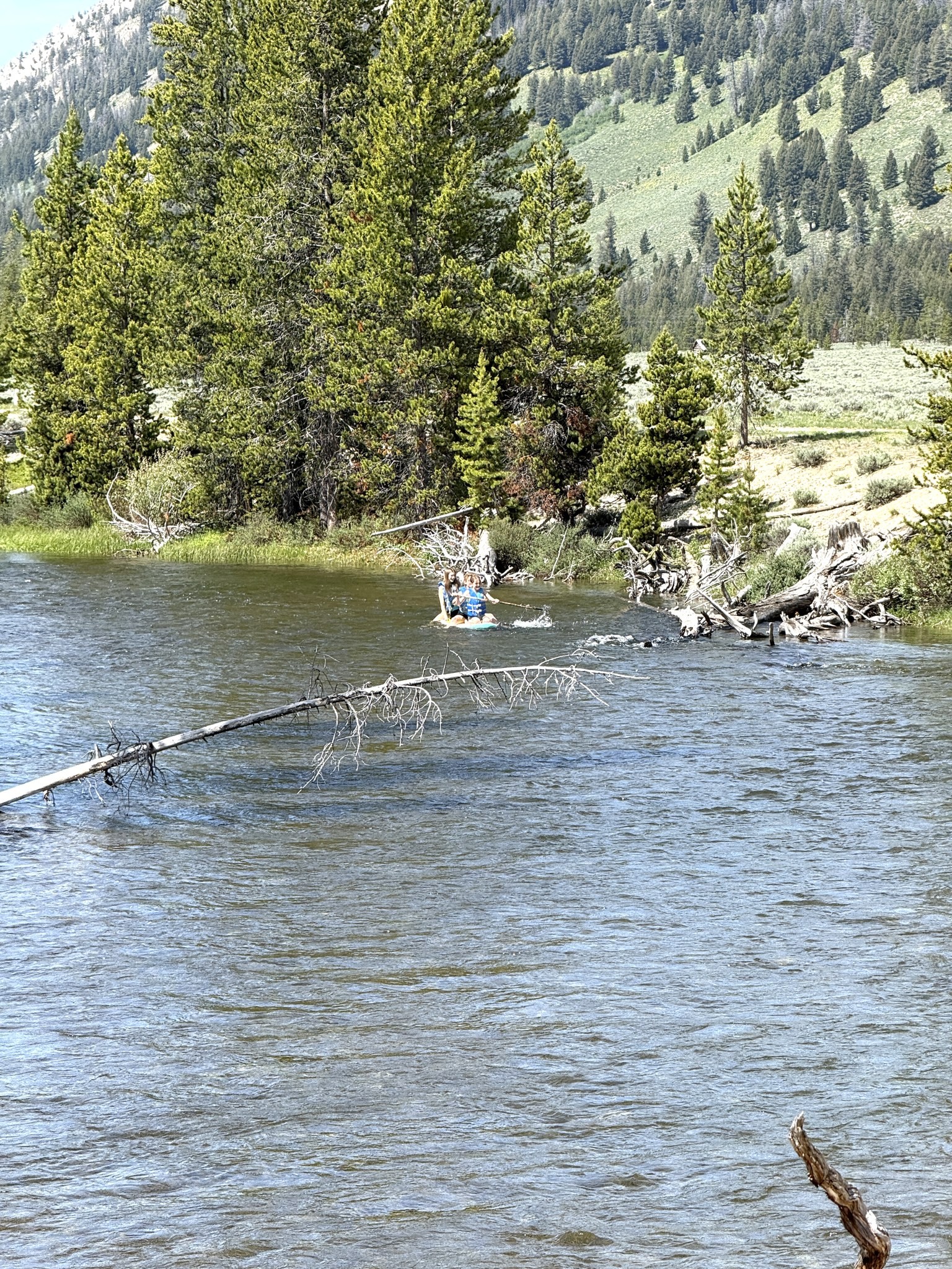 Kids floating the calm water from Perkins Lake to Old Cabins near Stanley, Idaho