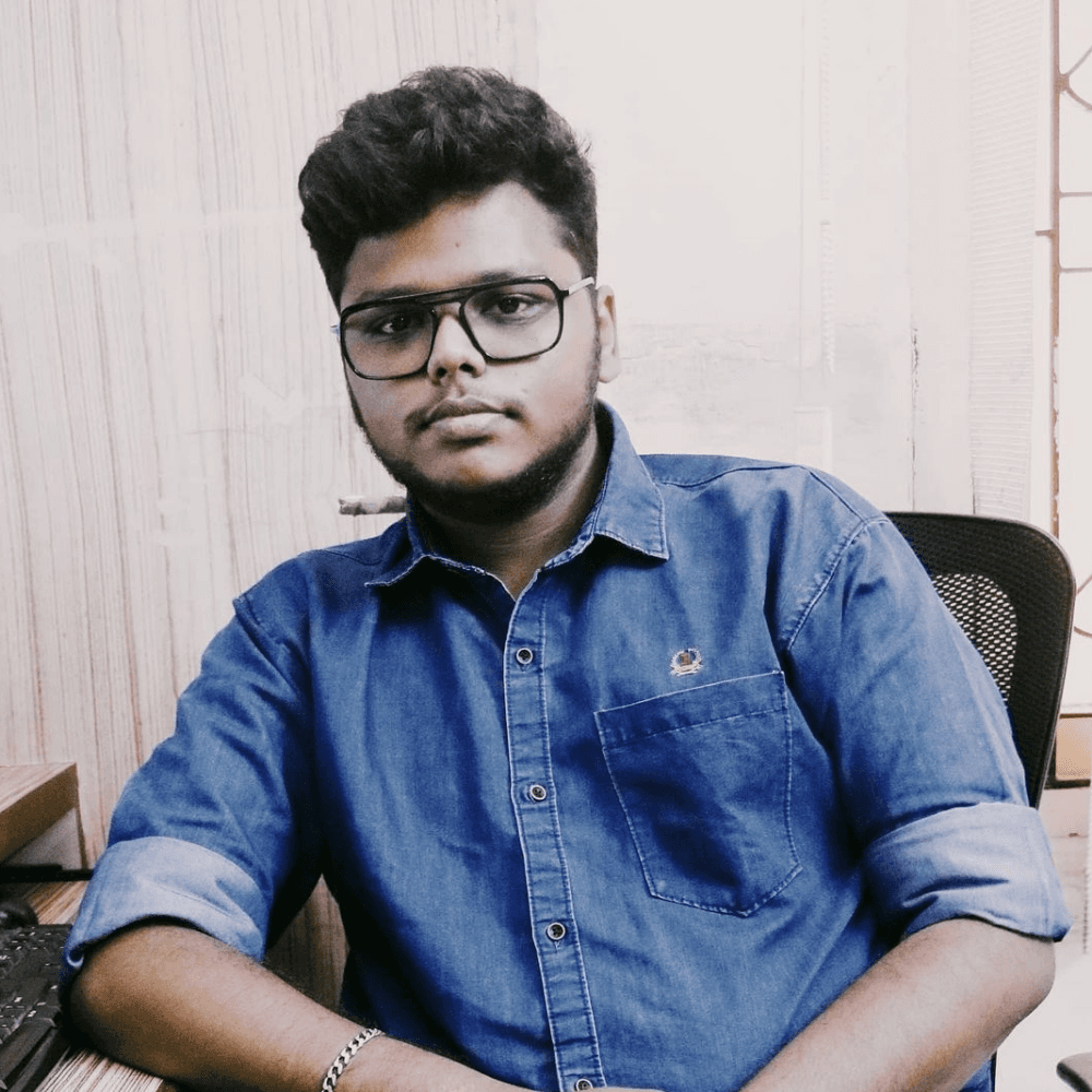 woman staring directly at camera near pink wall