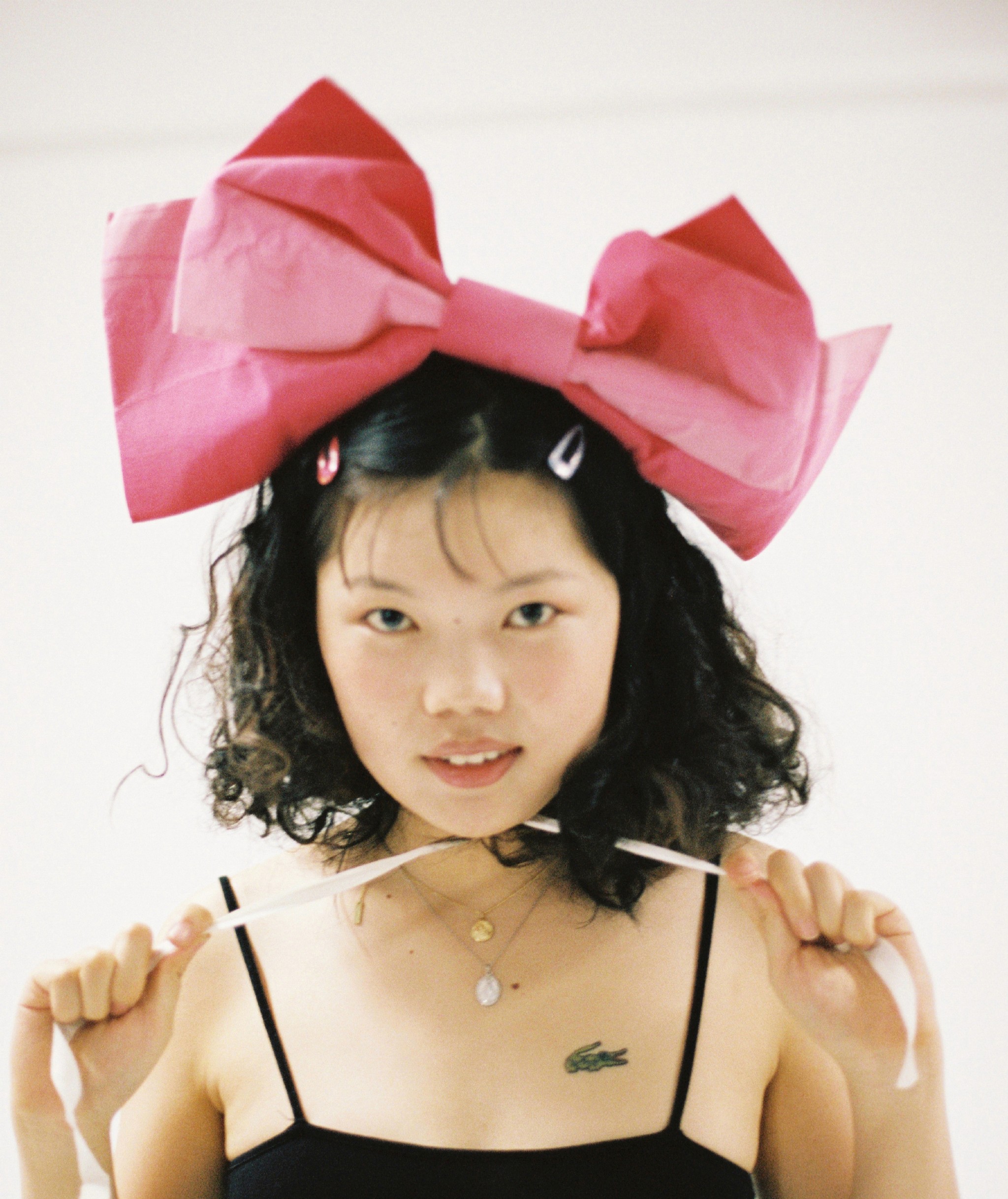 Yijing Wu wearing giant bow on head