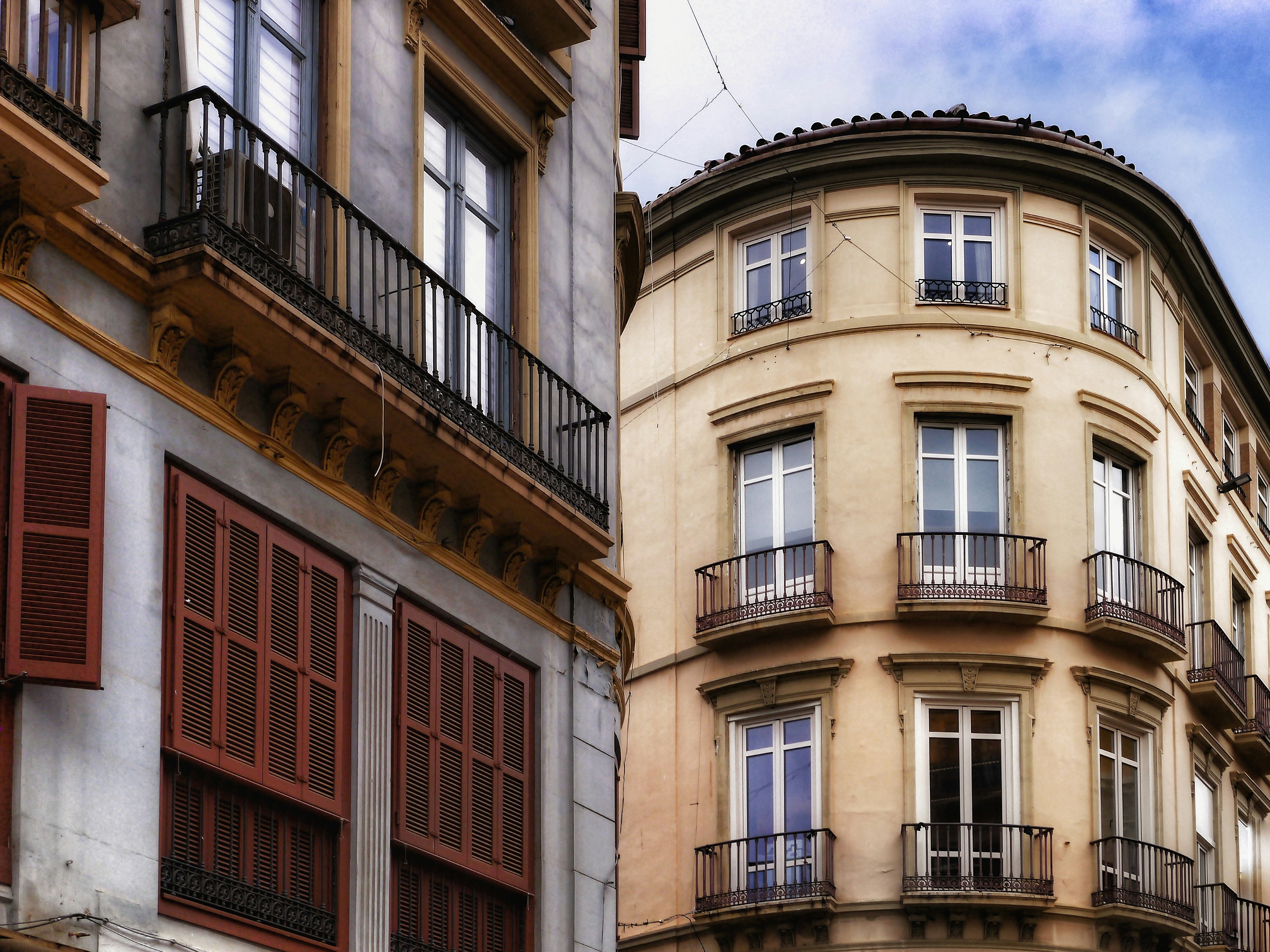 Ornate european buildings with balconies and shutters.