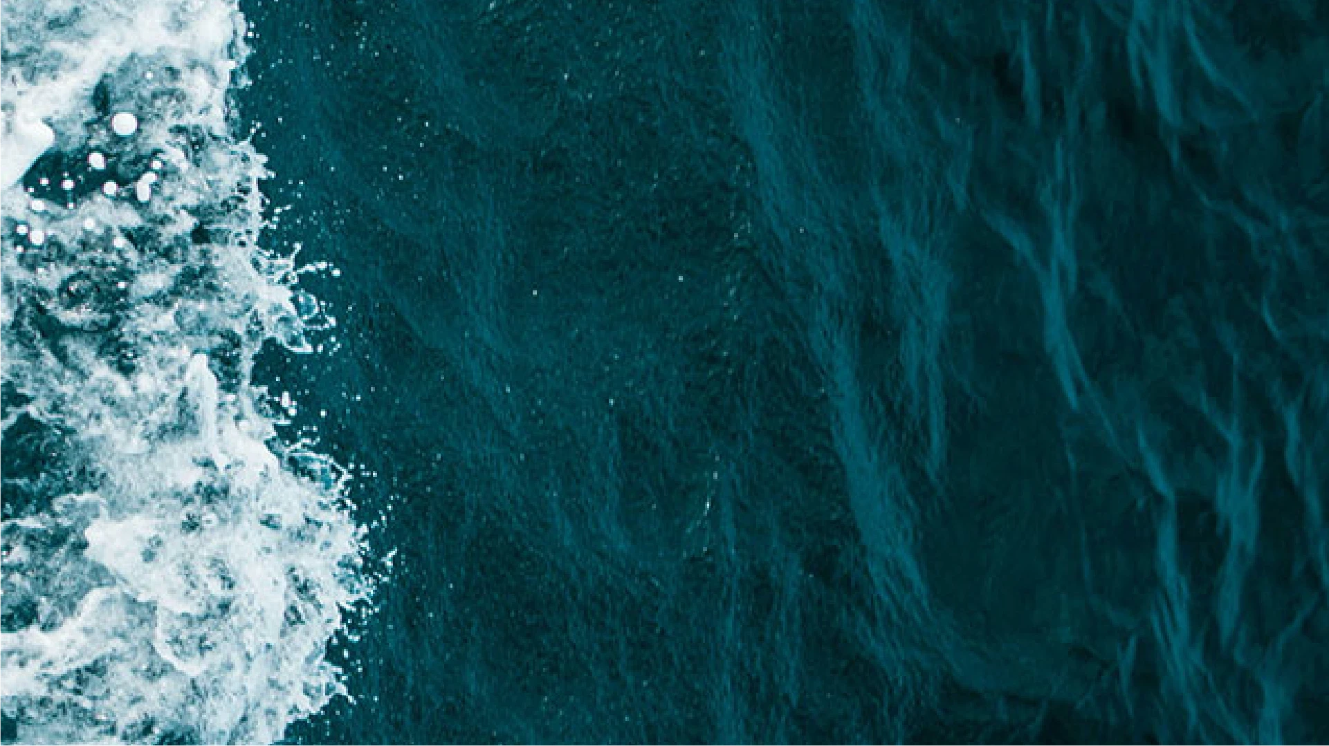 top down view of sea with waves on left