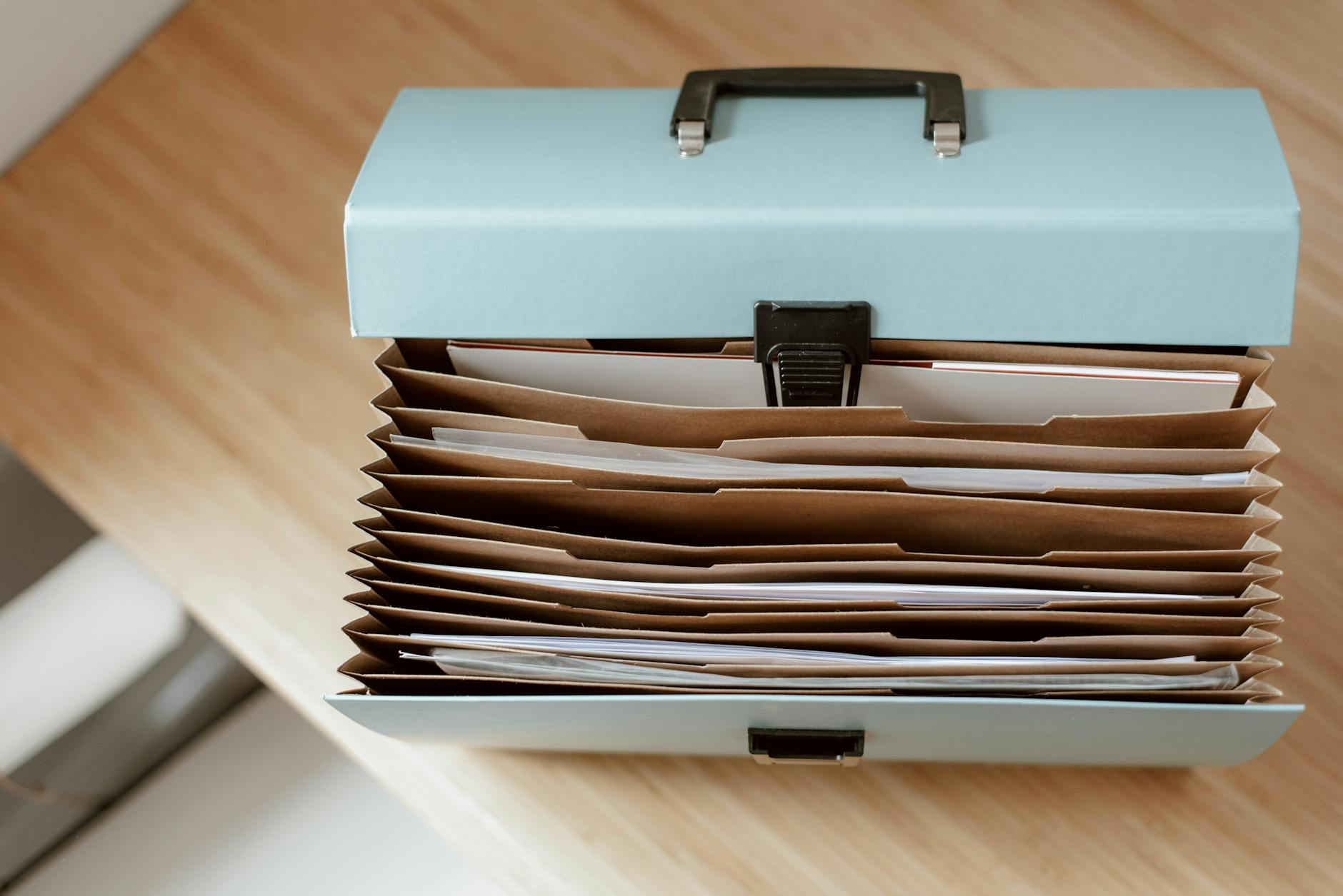 Close-up of a colorful mind map and organized printed questionnaire on a wooden school desk.