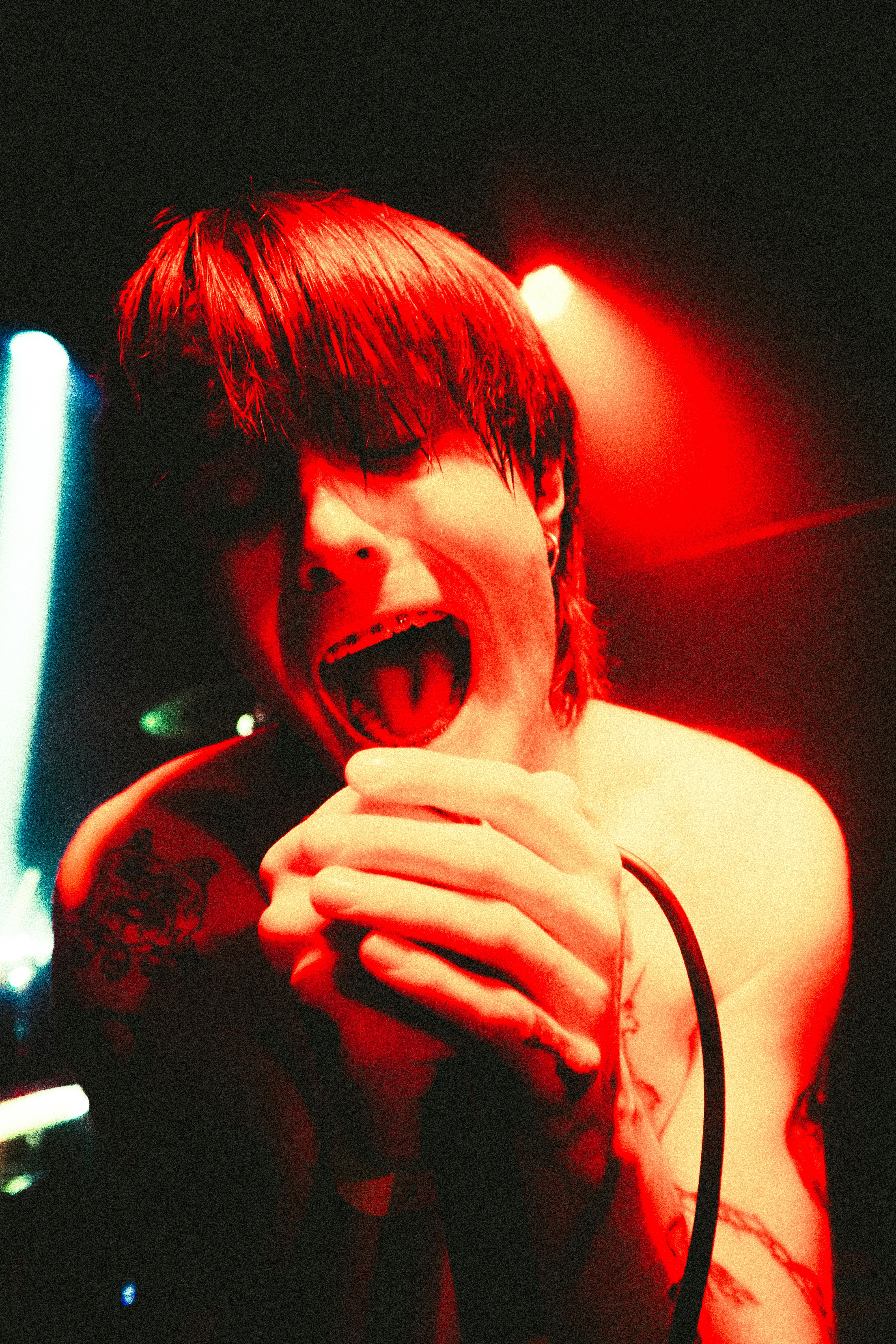 Man singing passionately into a microphone