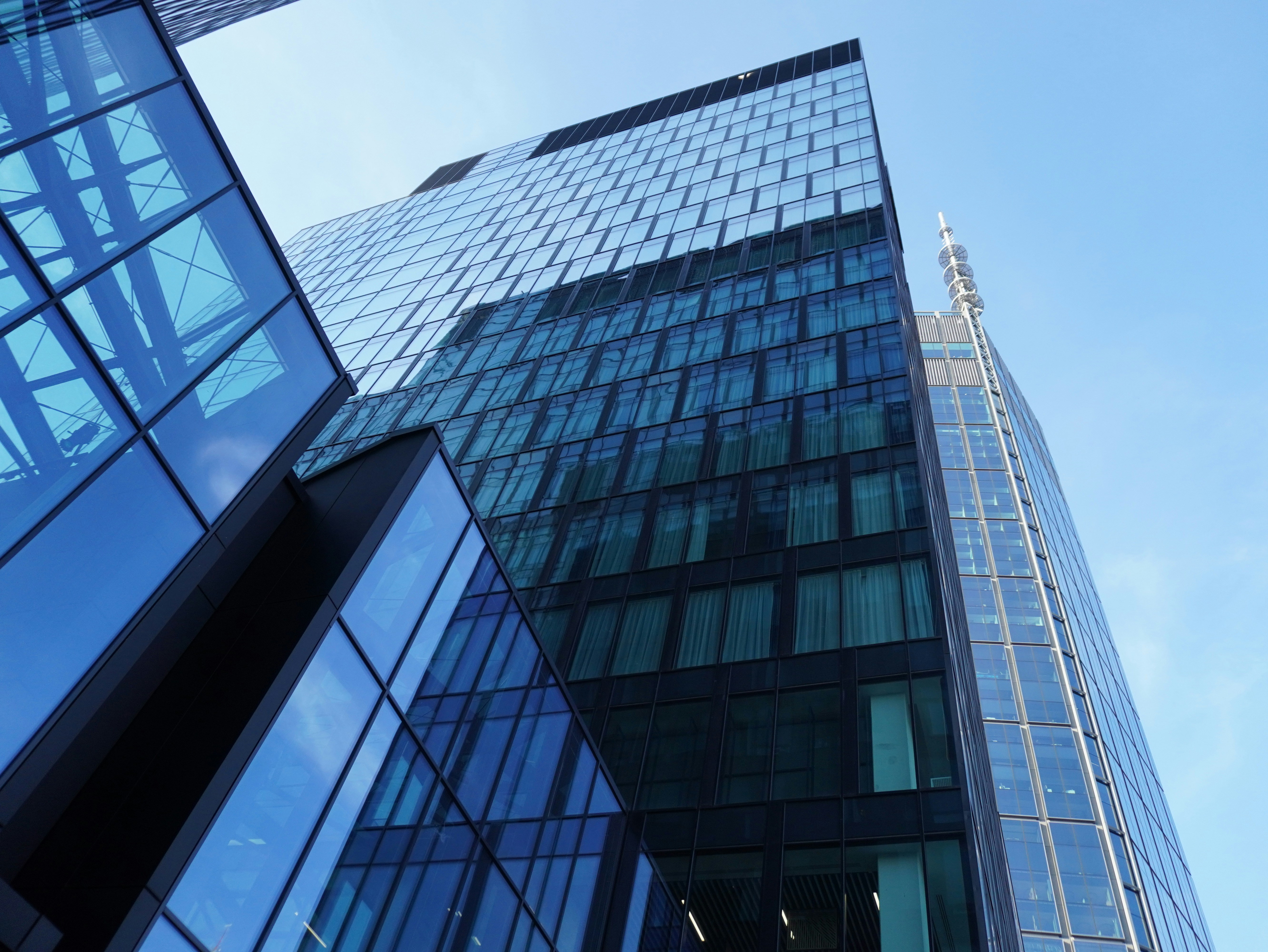 Modern glass buildings against a clear blue sky