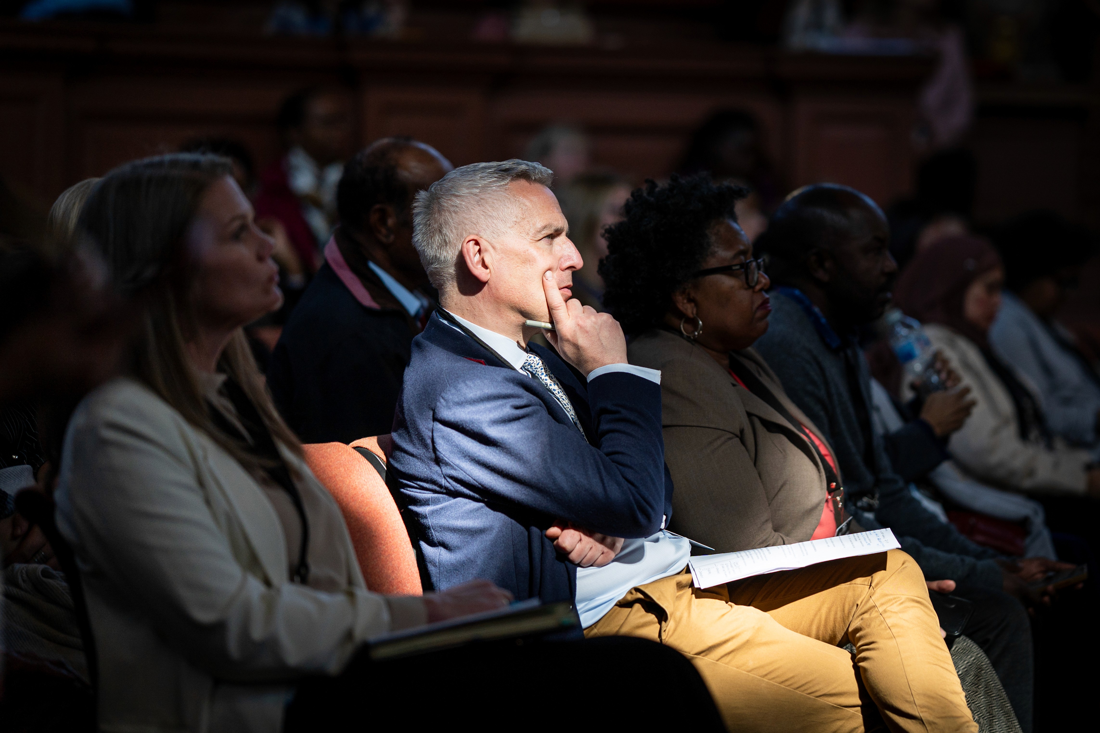 Scenes from an AI conference showing a speaker presentation and networking among product, technology, and artificial intelligence professionals.