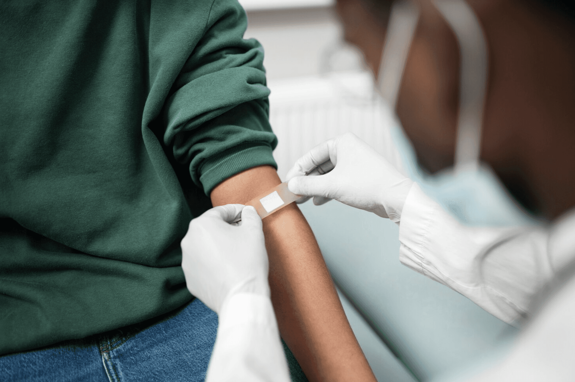 Doctor preparing an arm for an injection