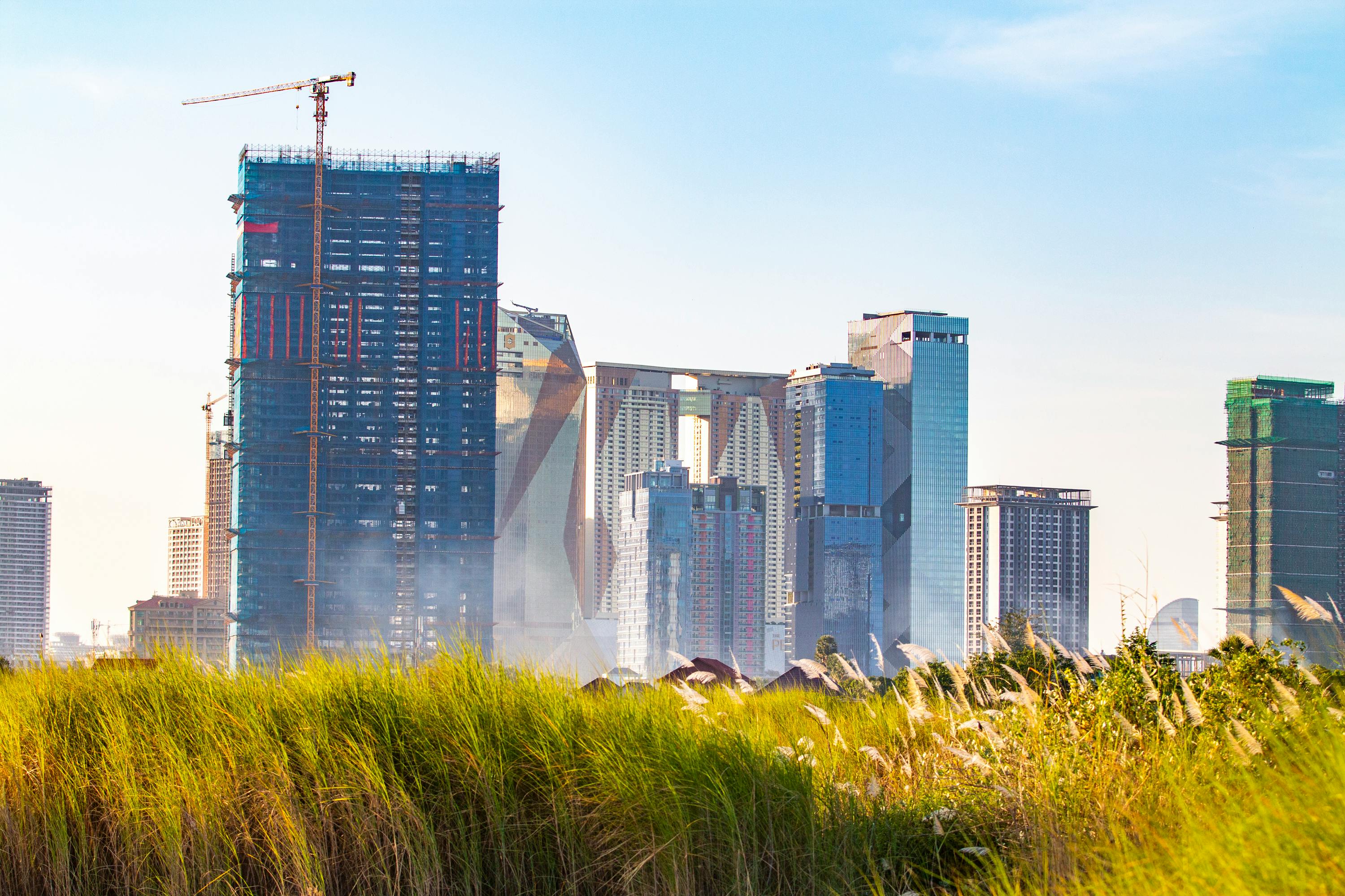 Phnom Penh skyline featuring multiple high-density towers under construction, highlighting the scale of urban development and the importance of long-term asset performance