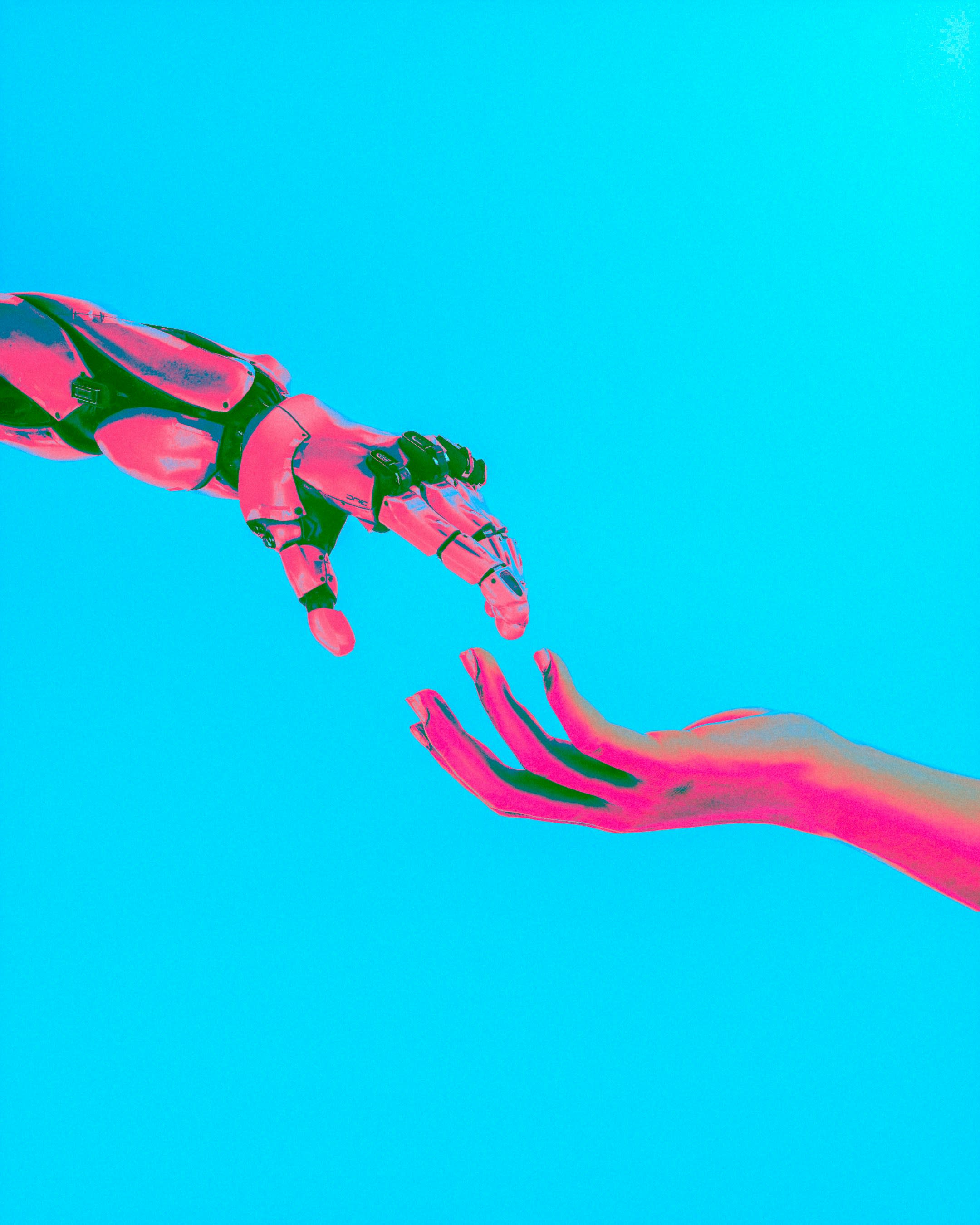 Image of a robot hand and human hand almost touching each other