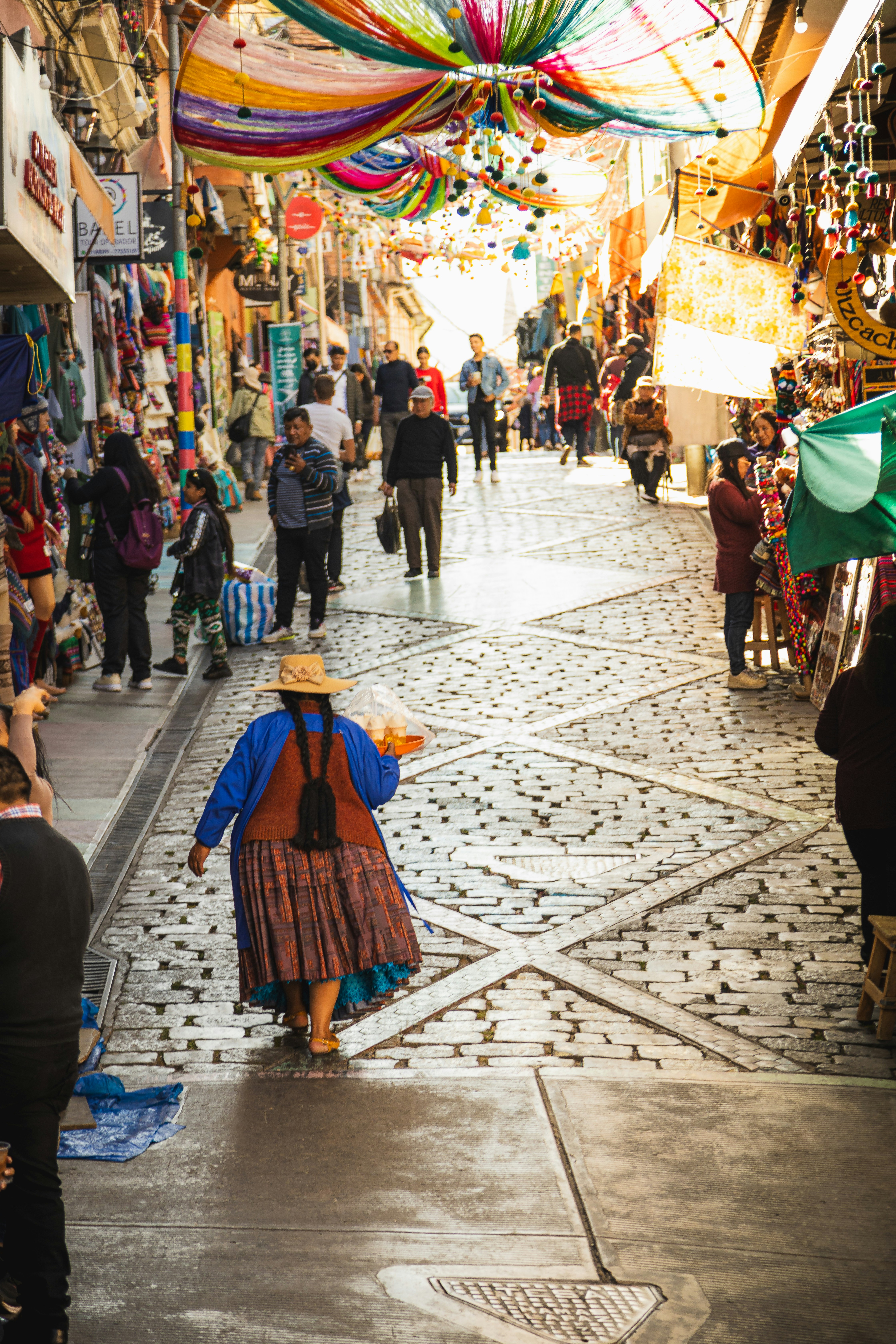 a woman walking down a street next to a crowd of people