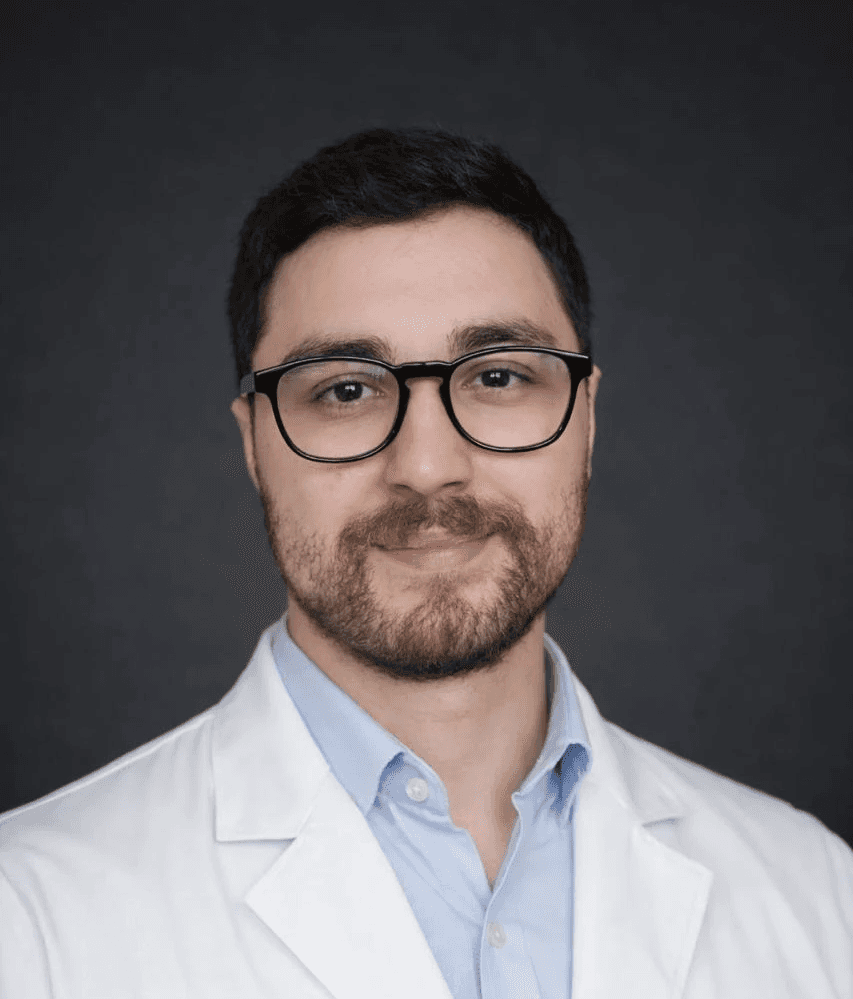 man in blue crew neck t-shirt smiling