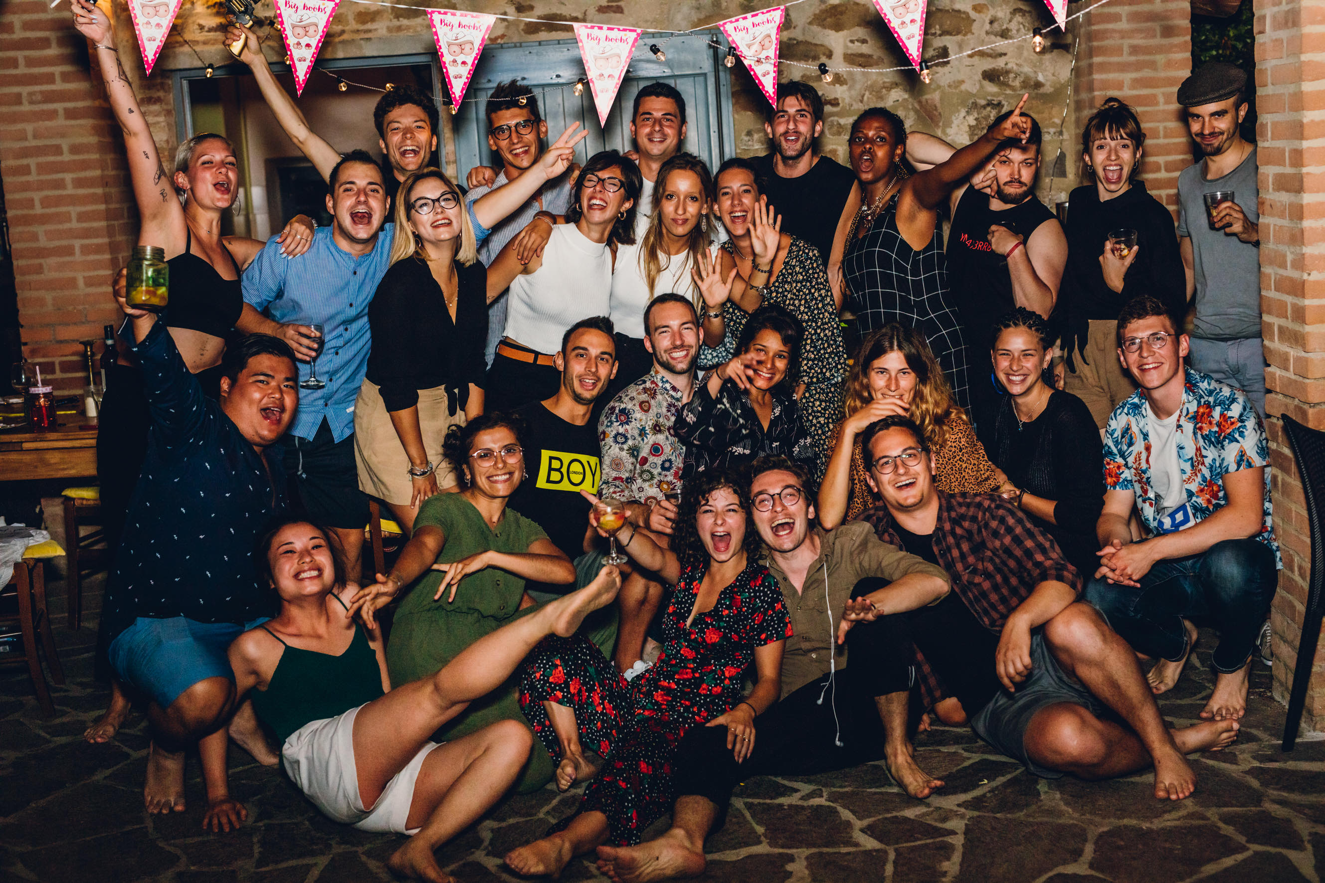 Woman in a light suit sitting thoughtfully against a terracotta wall
