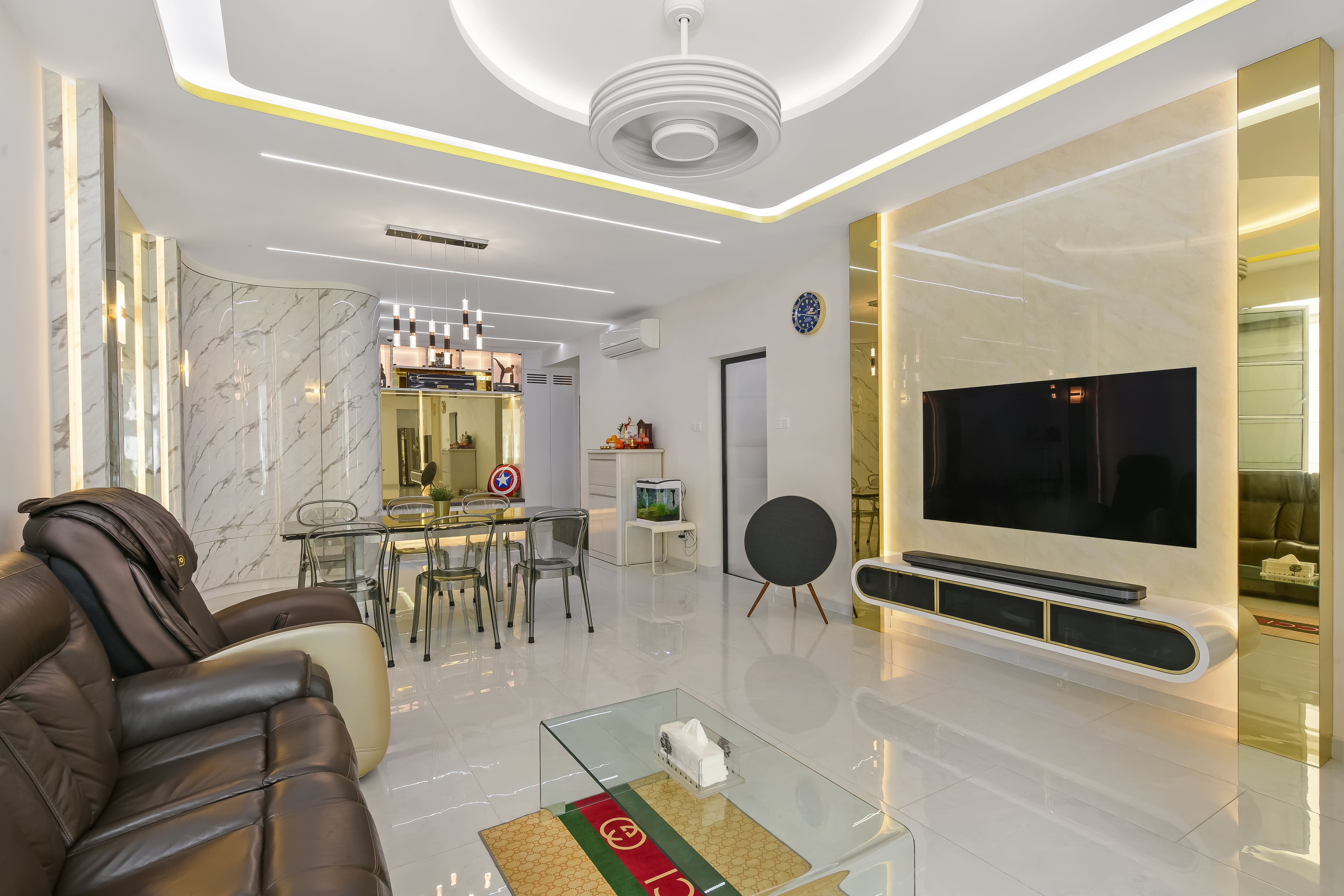 Open-concept living and dining space with marble finishes, statement lighting, and a streamlined entertainment wall for a luxurious yet functional setting.