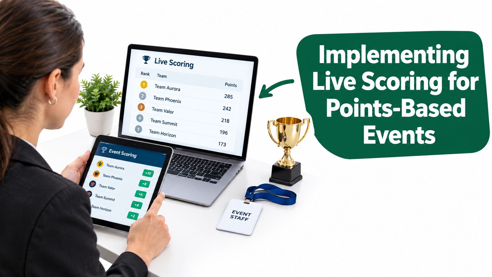 A professional managing live scoring for points-based events using a laptop and tablet at a workspace.