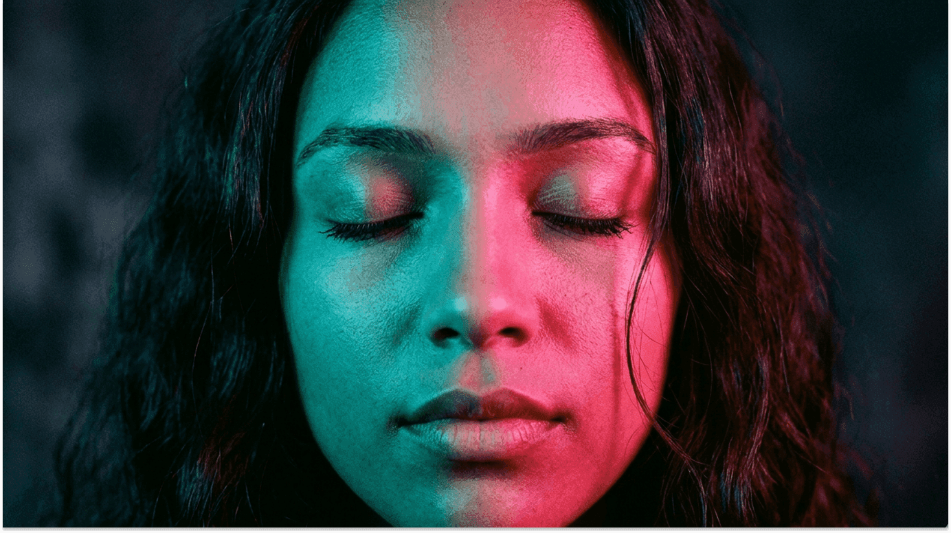 Silhouetted woman raises arms in yoga pose inside lush forest.