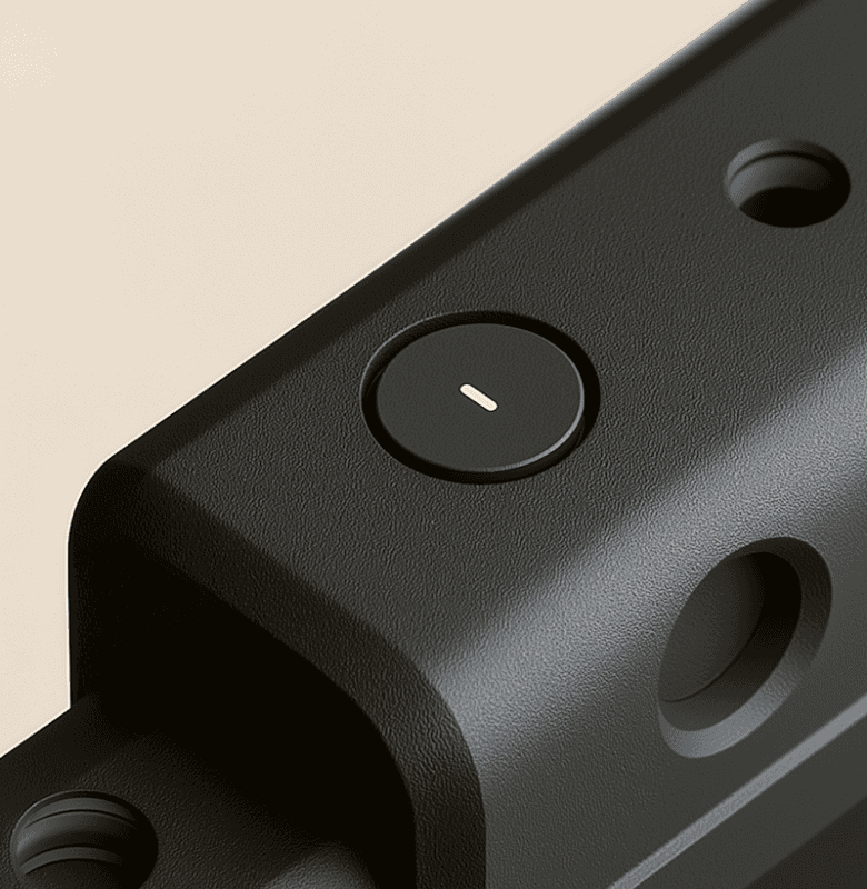 Close-up of a black device with a circular power button and smooth matte finish.