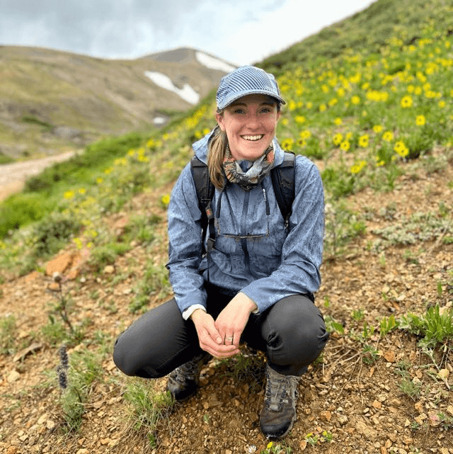 Melissa, Social Media Manager at Rod Society fishing travel agency, fly fishing in a mountain river destination