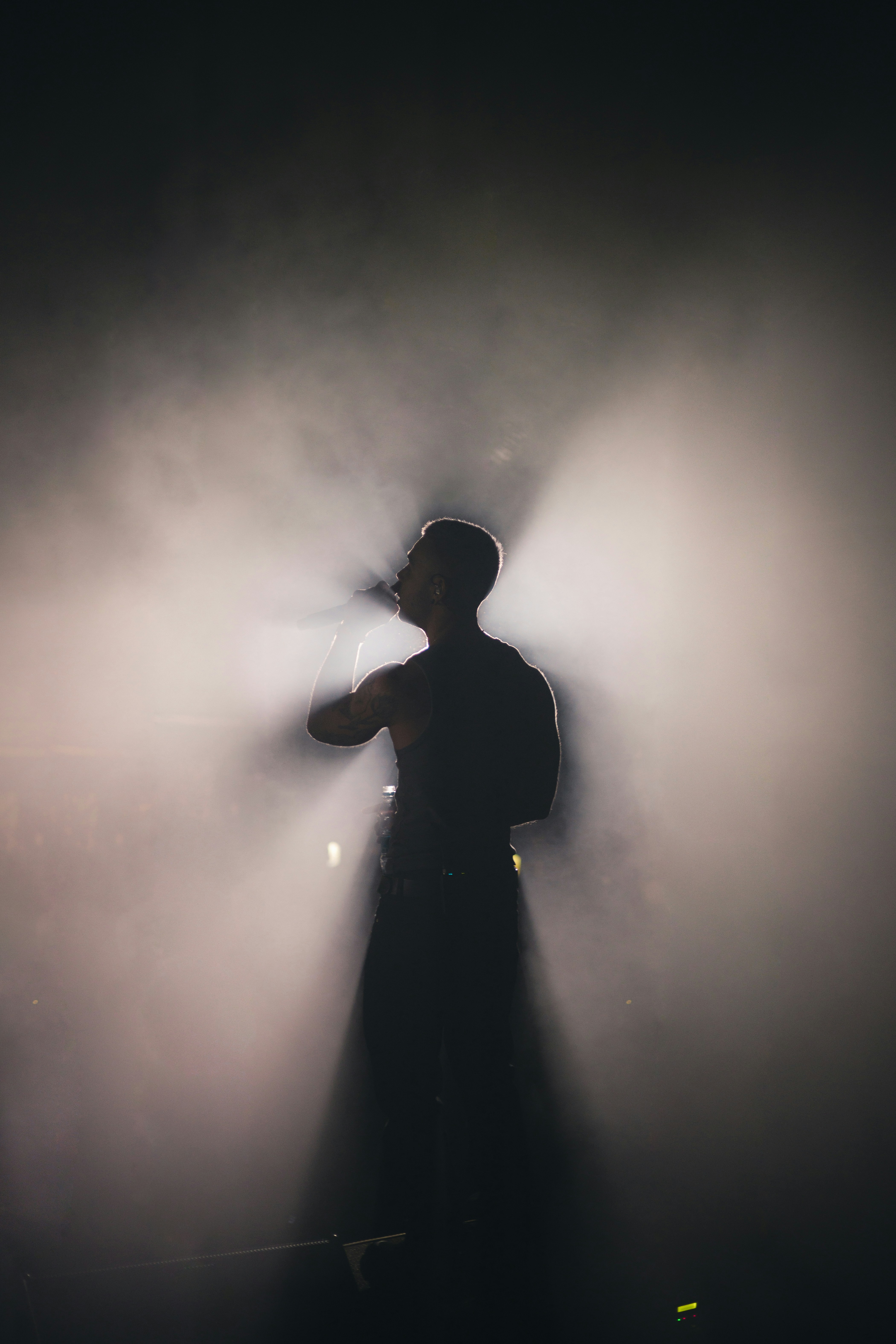 a man standing in front of a spotlight on a stage