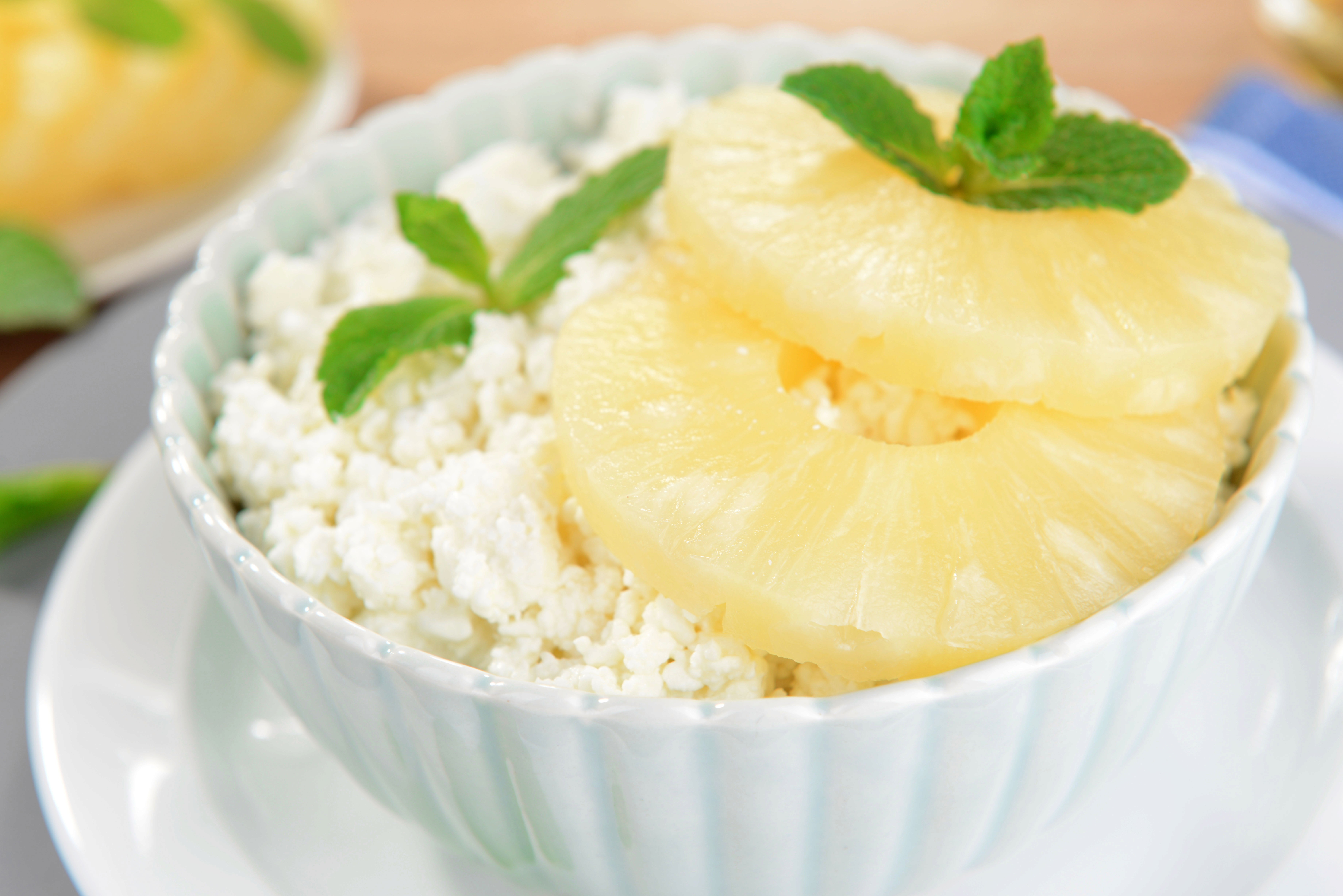 Low-fat cottage cheese topped with pineapple chunks in a white bowl