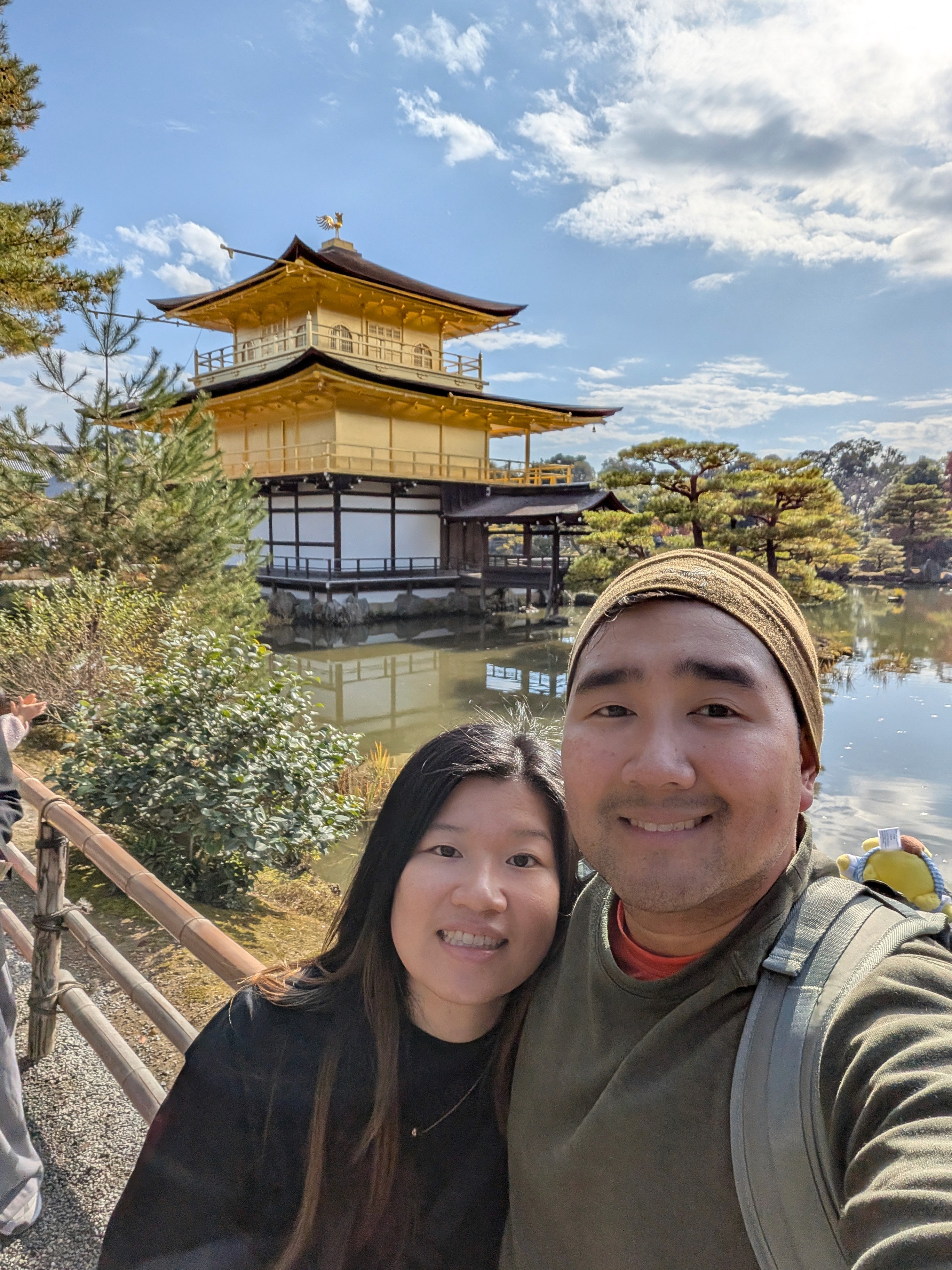 Close-up of two hands gently clasped, one wearing a sparkling engagement ring. The soft lighting and pastel nails evoke a sense of romance and intimacy.