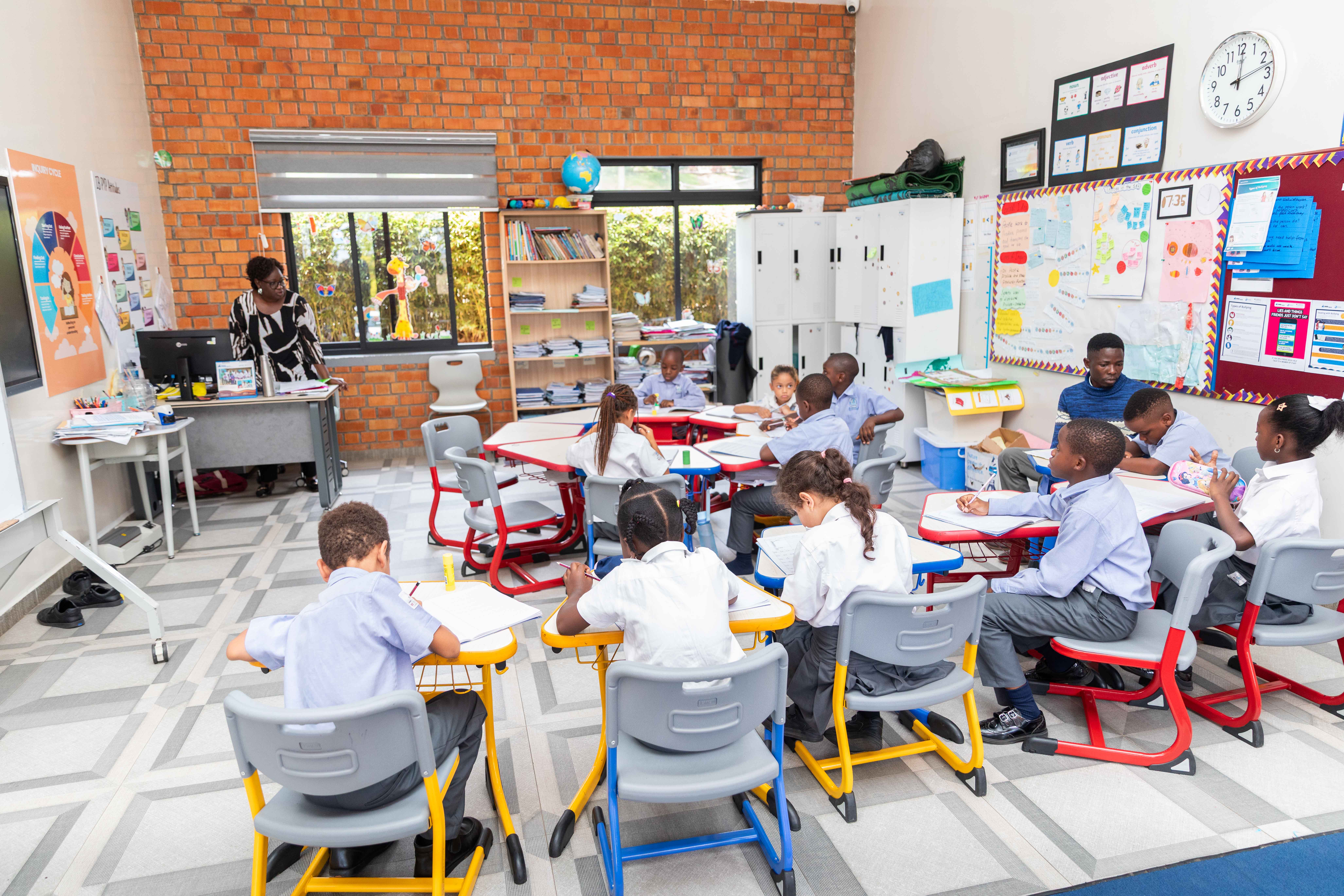 A student wearing a yellow t-shirt sits with a calm expression