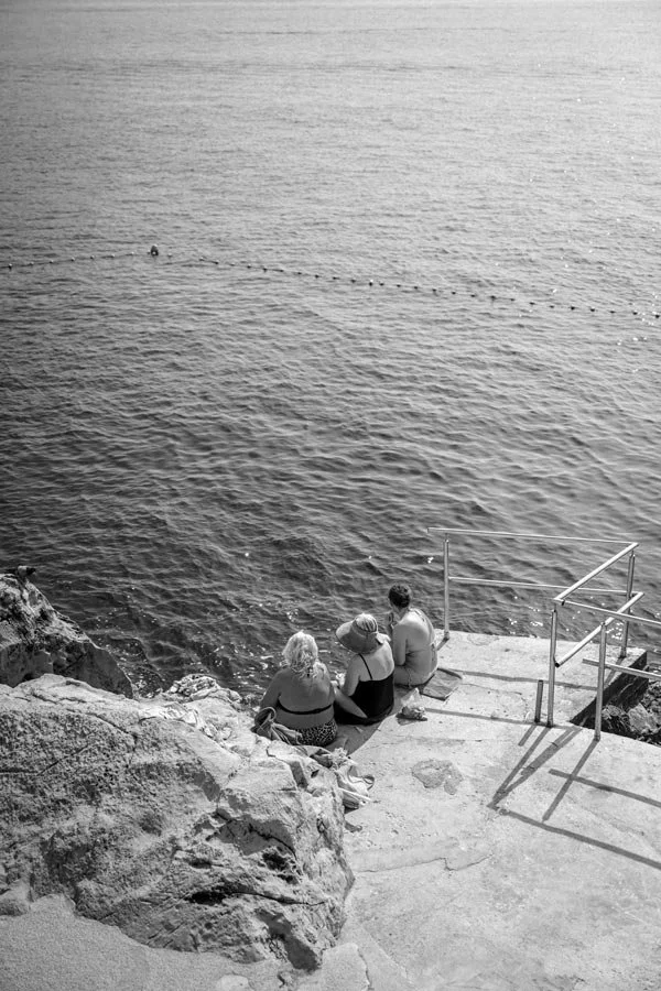 People sitting by the Dubrovnik water