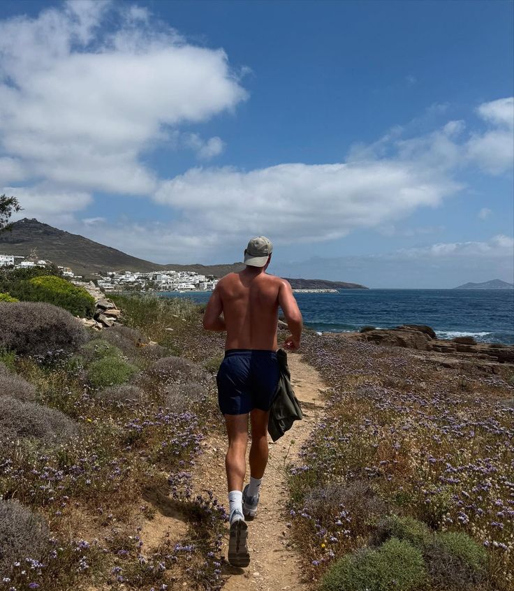 Stylish woman wearing an oversized cream quarter-zip sweatshirt and large sunglasses, looking to the side against a peach-colored wall.