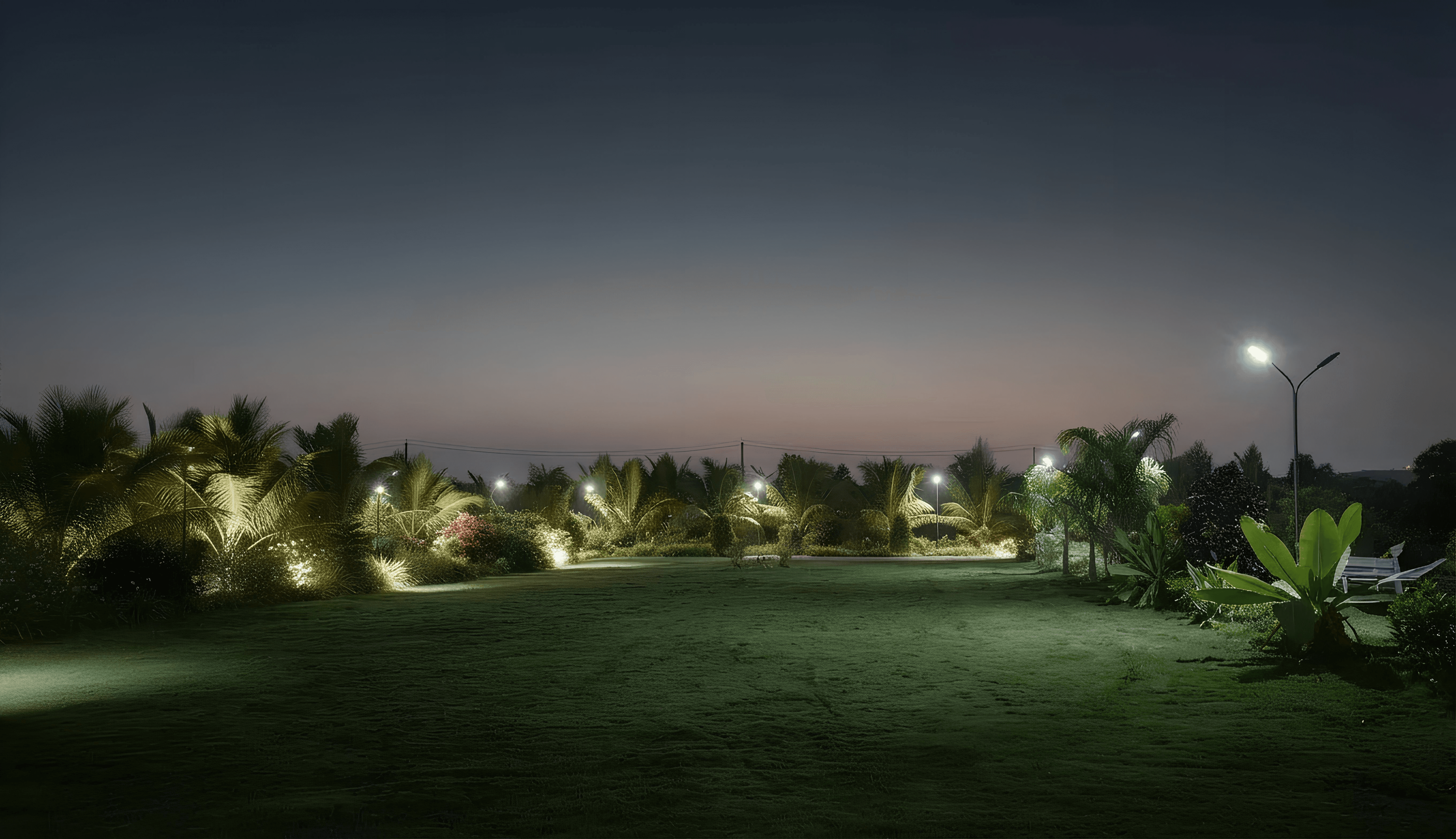 a corner of a room with a chair and paintings