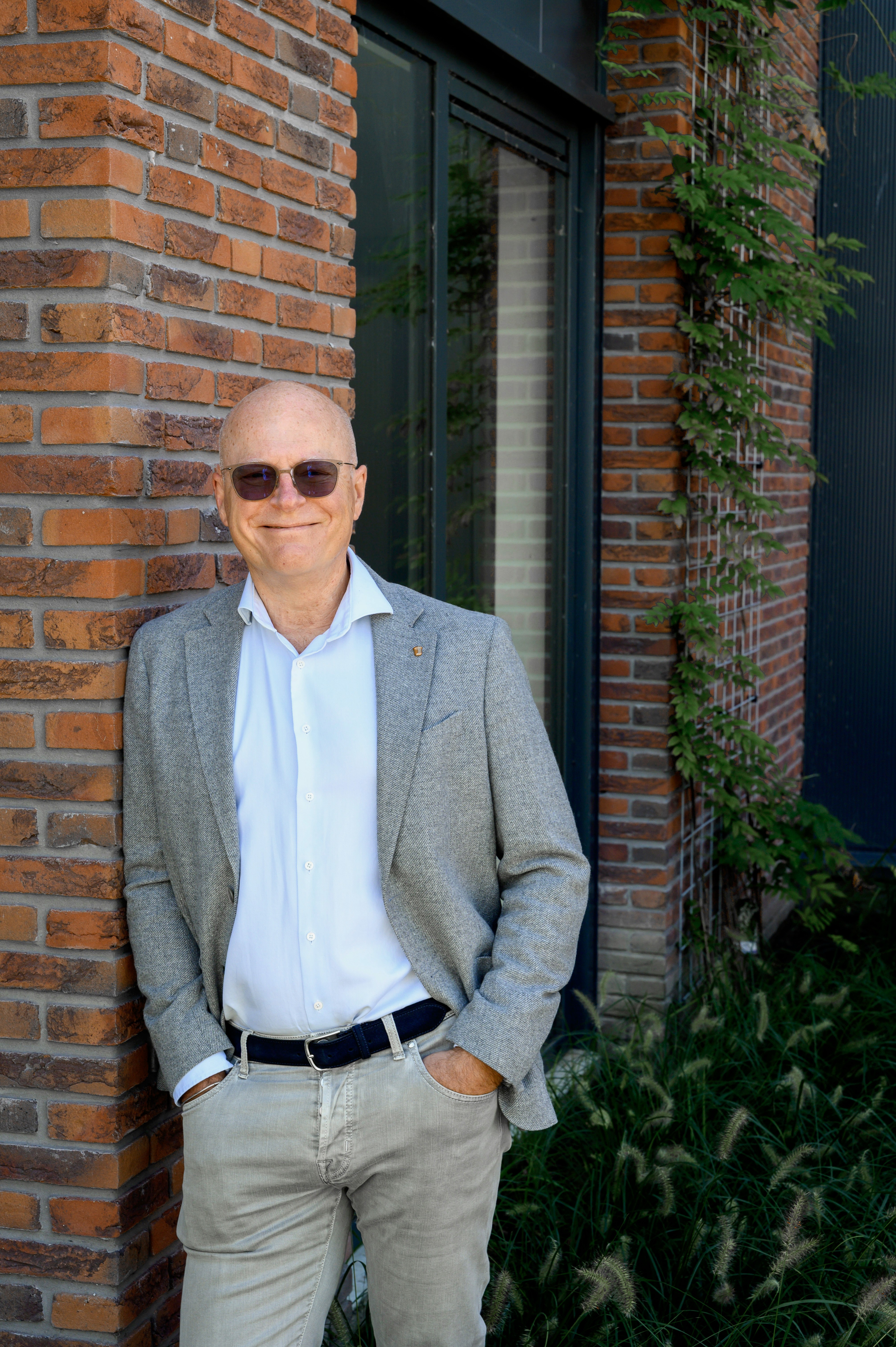 a man and woman sitting at a table with an open book