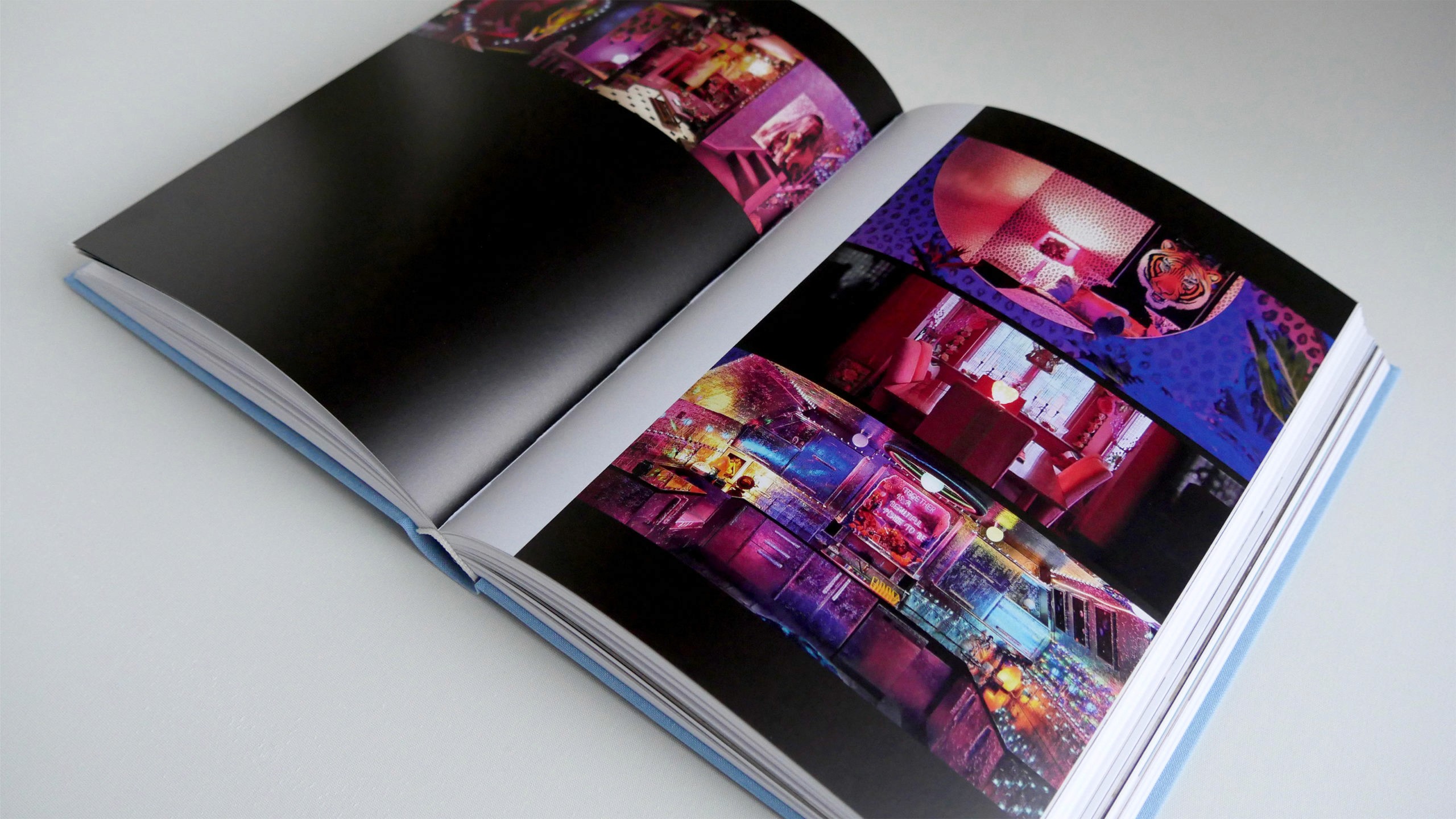 Uchronia book opened to a colorful collaghe of photos