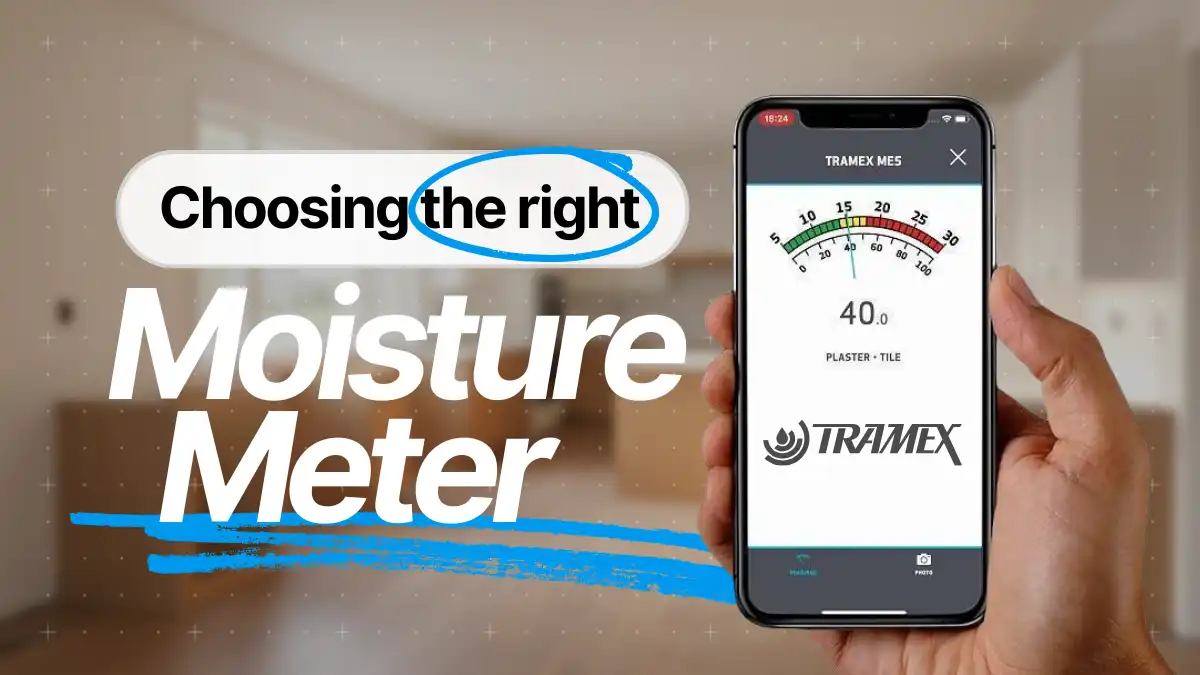 Hand, die eine Tramex-Feuchtigkeitsmessung zeigt