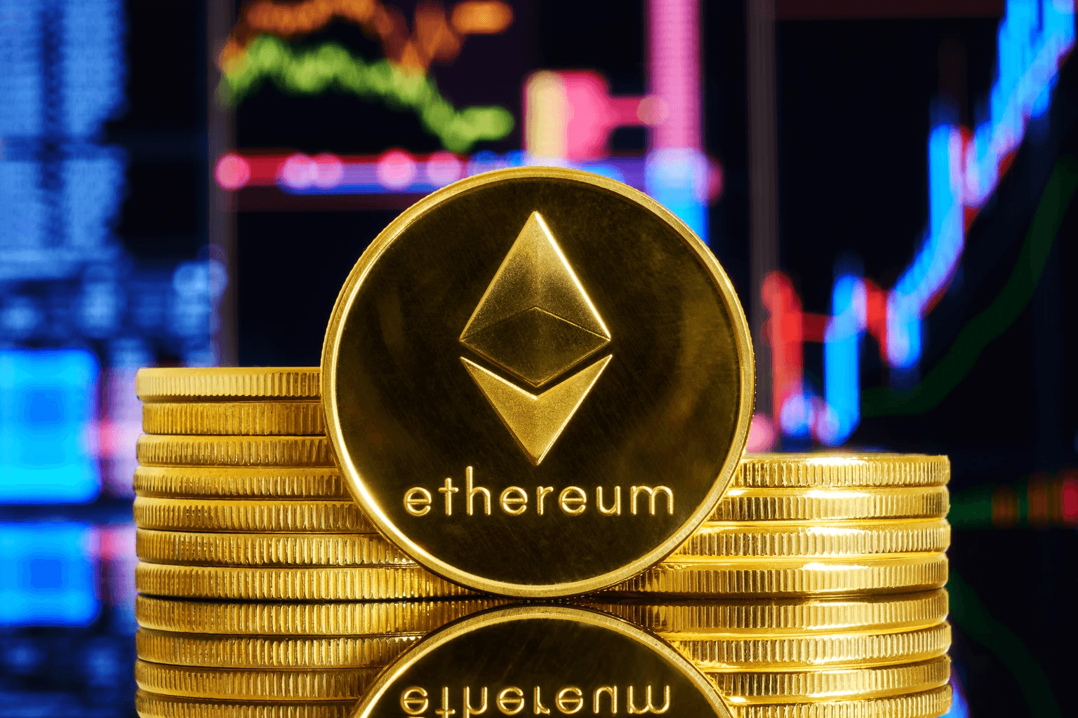 Stacked gold Ethereum coins with charts - Ethereum Tokenomics