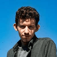 grayscale photo of man wearing blazer