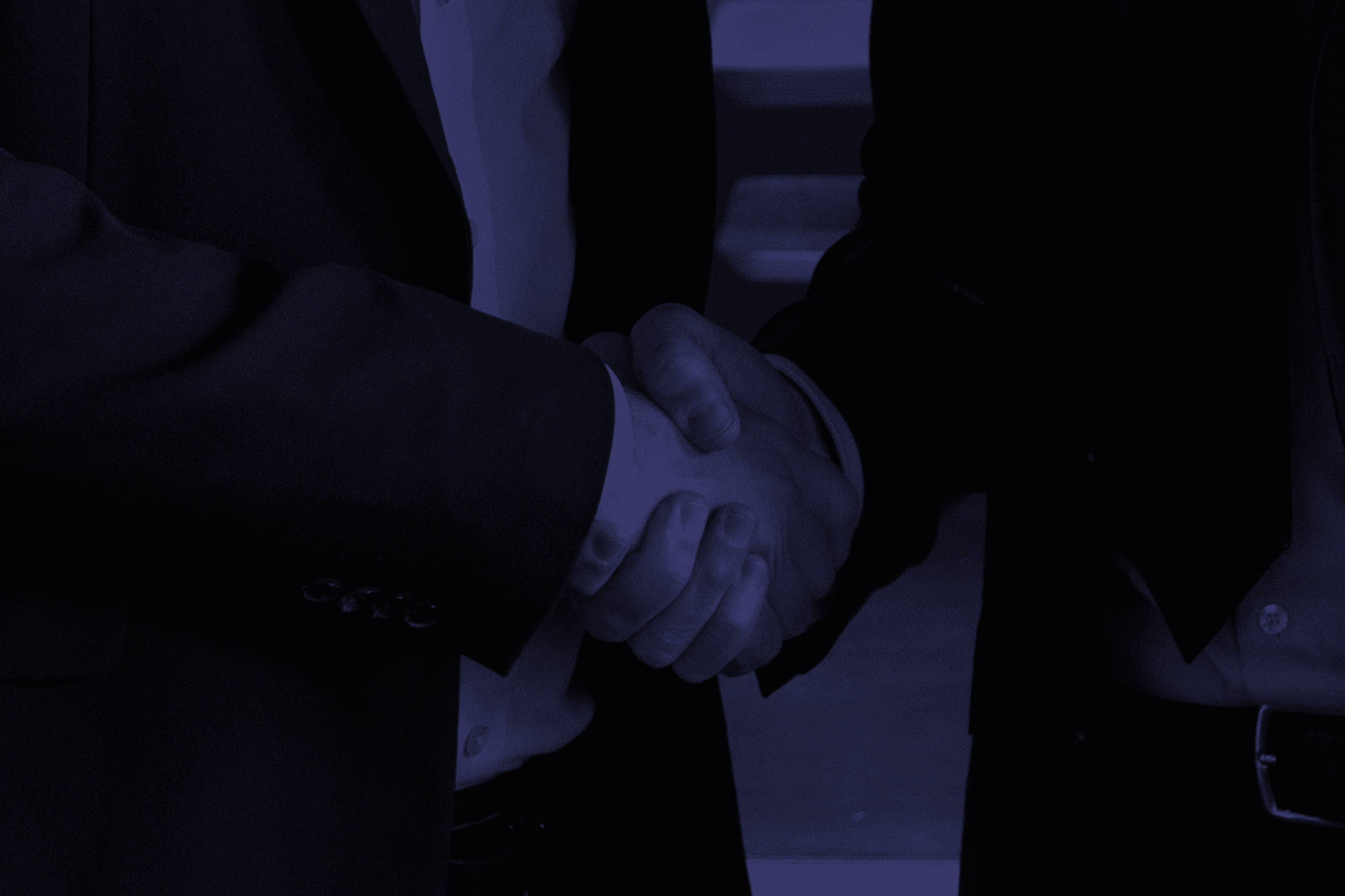 Business partners shake hands, making a deal.