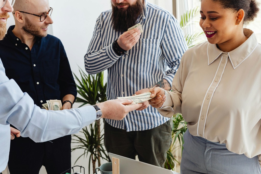 Business professionals exchanging money