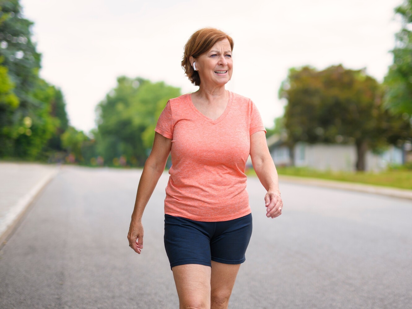 woman taking a brisk walk to reach her walking two miles a day weight loss goal while increasing intensity to improve fitness
