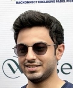 man in gray crew neck t-shirt and gray shorts sitting on basketball court