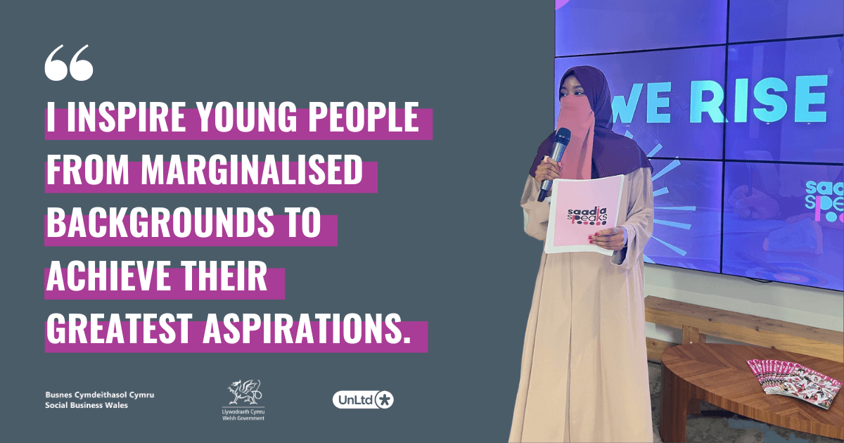 A woman in a burqa giving a talk holding a mic and a graphic of a quote in English highlighted in purple.