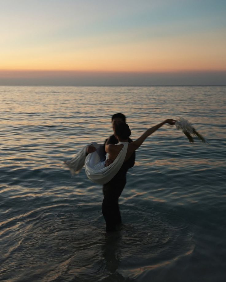 The wedding backdrop is the open sea, shimmering under late afternoon light