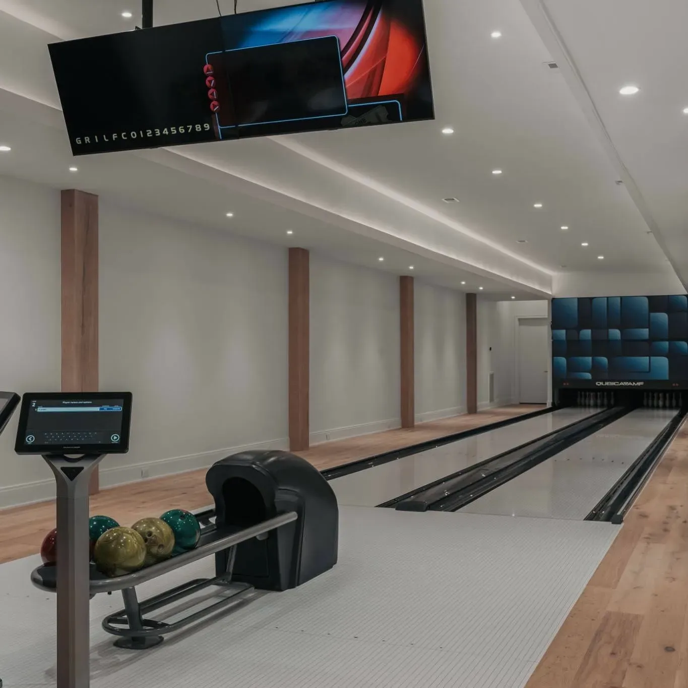An indoor bowling alley with lanes and modern lighting.