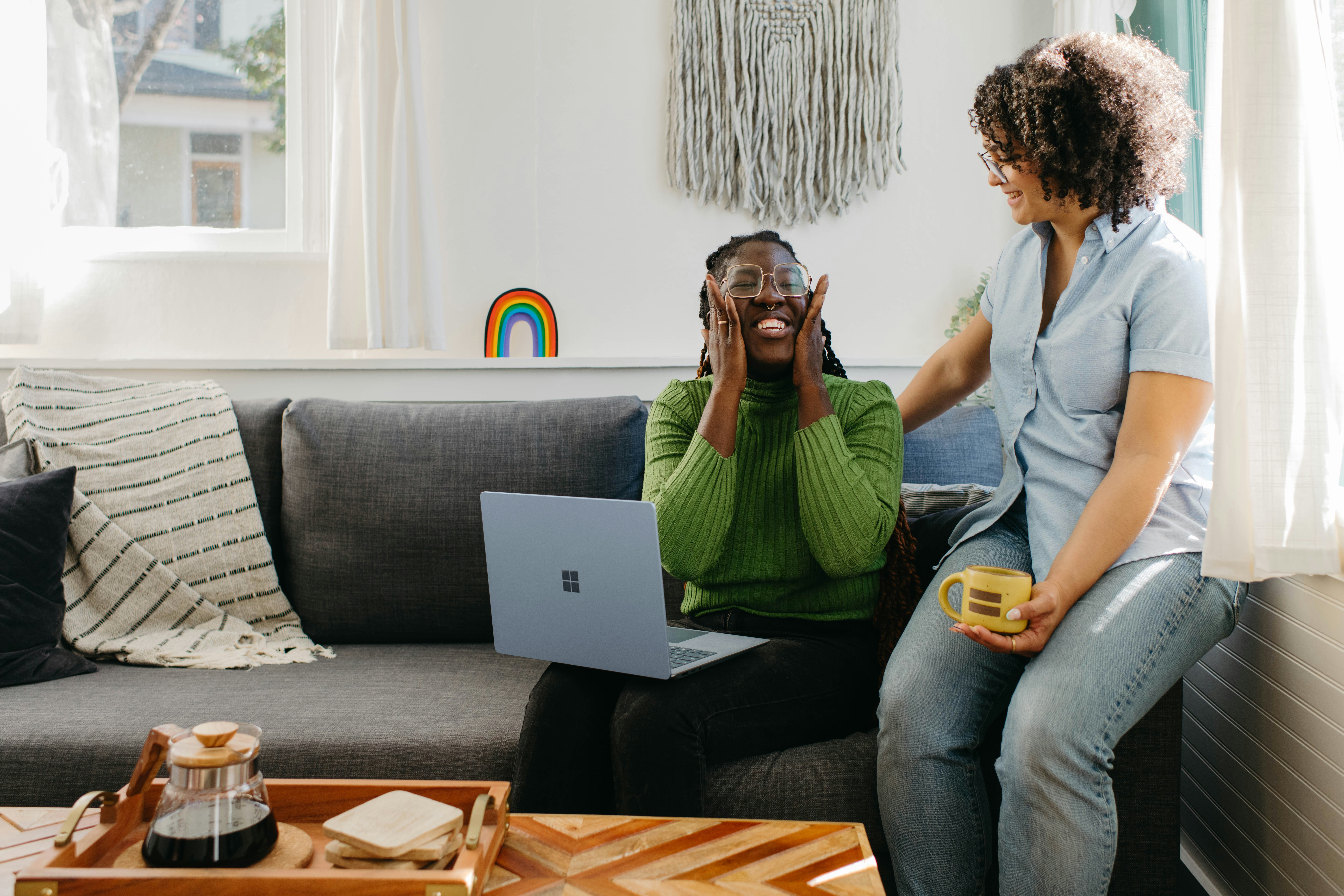 woman holding a phone and man looking at the phone. both are smiling