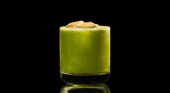 A closeup of a Matcha My PR cocktail against a dark background.