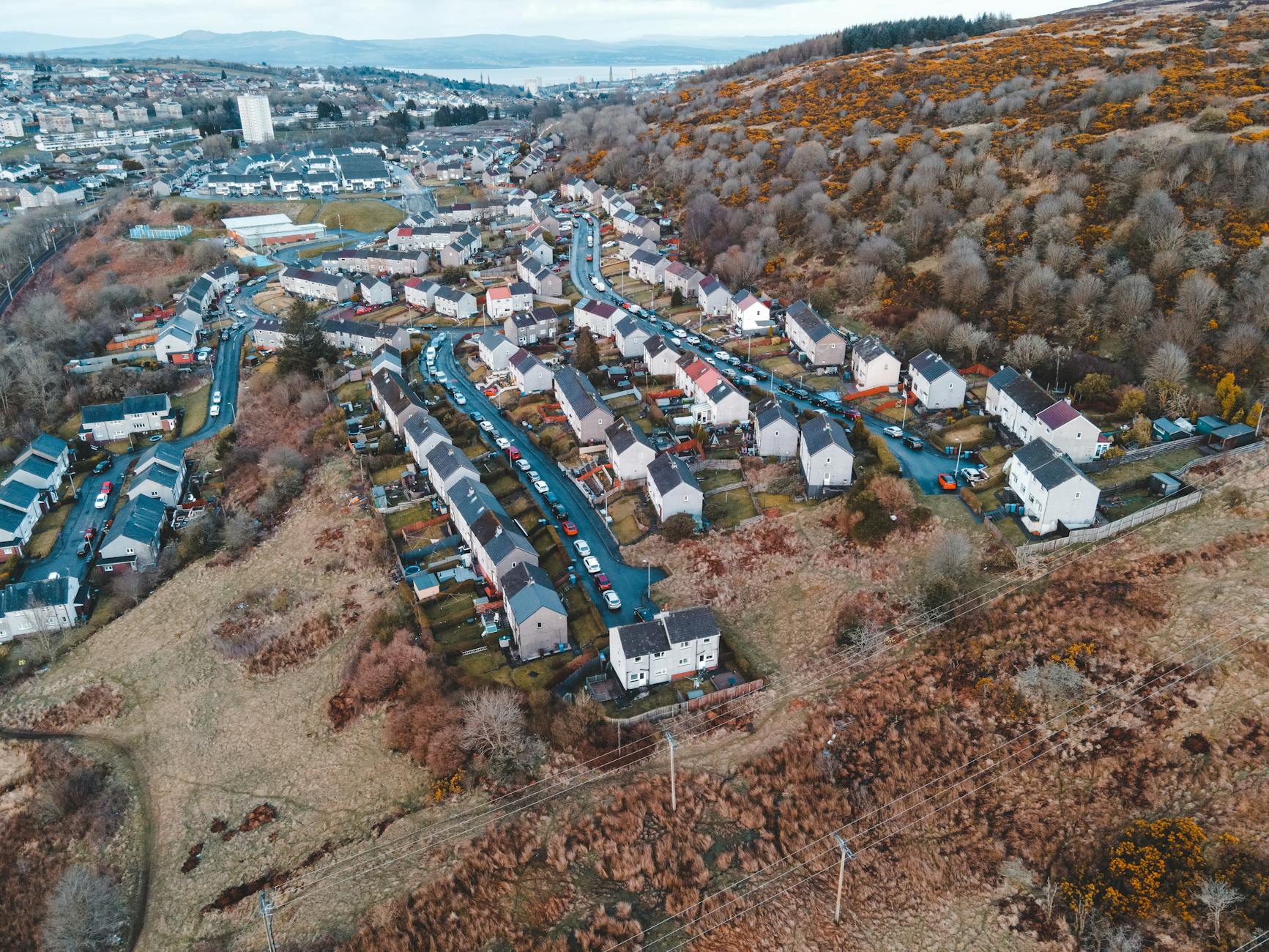 Two architects in hard hats examining the exterior of a modern white building with large windows