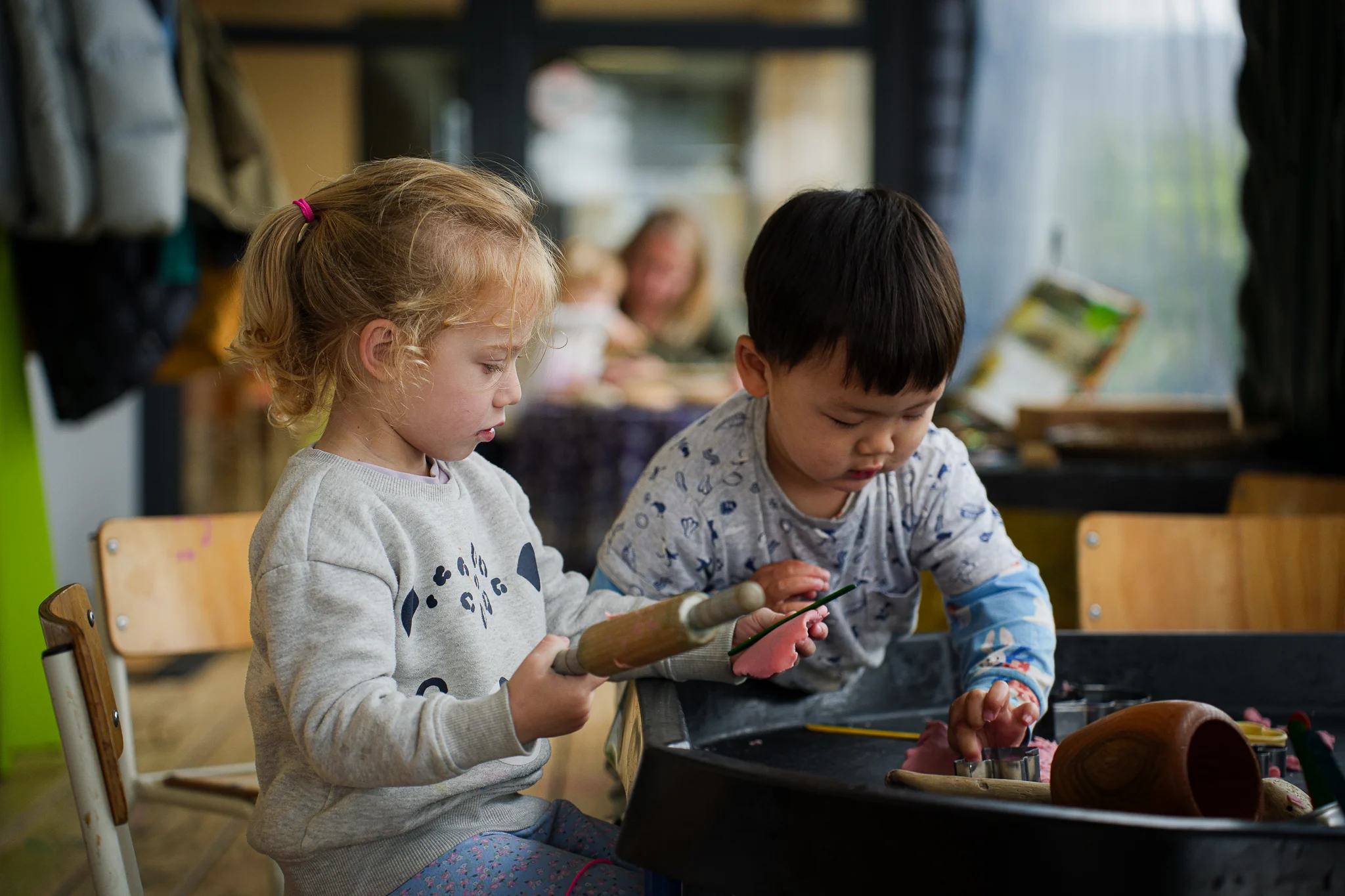 A teacher reading an illustrated book with young children during group time.