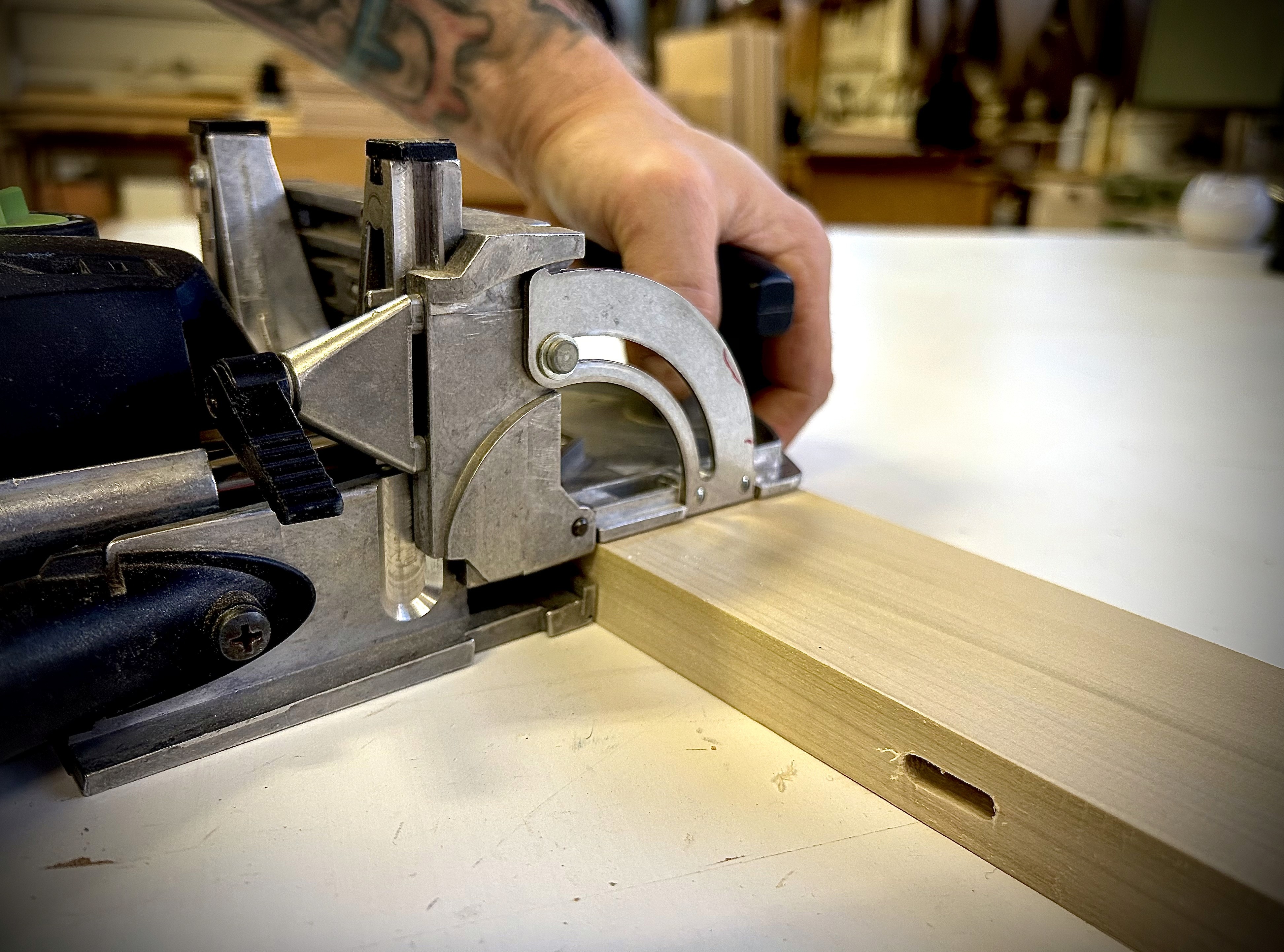 Woodworker using woodworking tool called a domino joiner