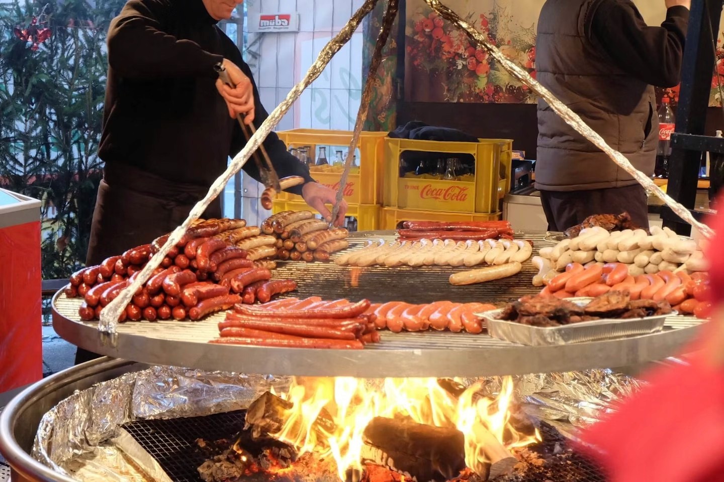 A couple of people standing in front of a christmas display