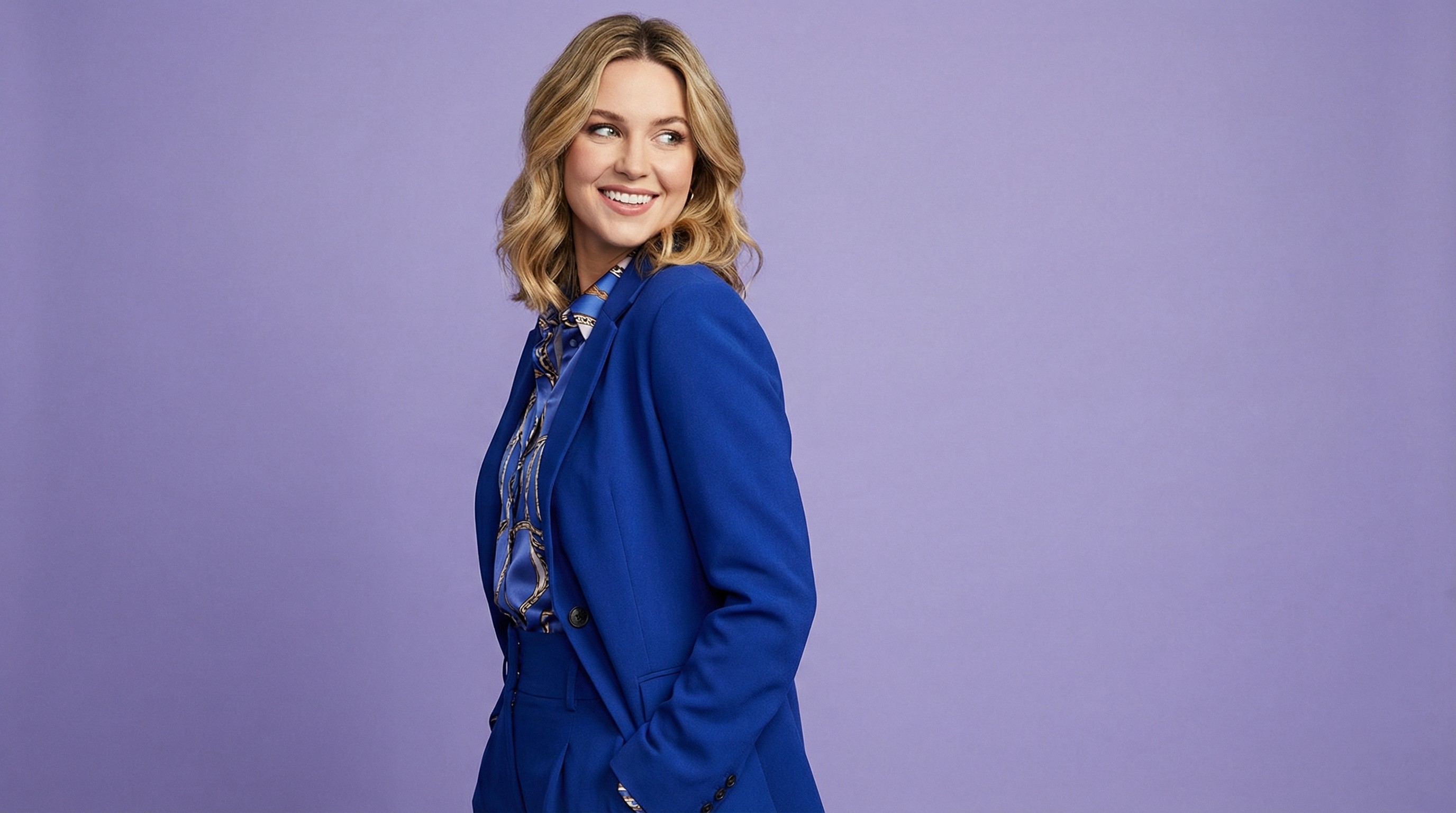 Close-up of lush, dark green leaves, some glossy and wet, against a muted background.