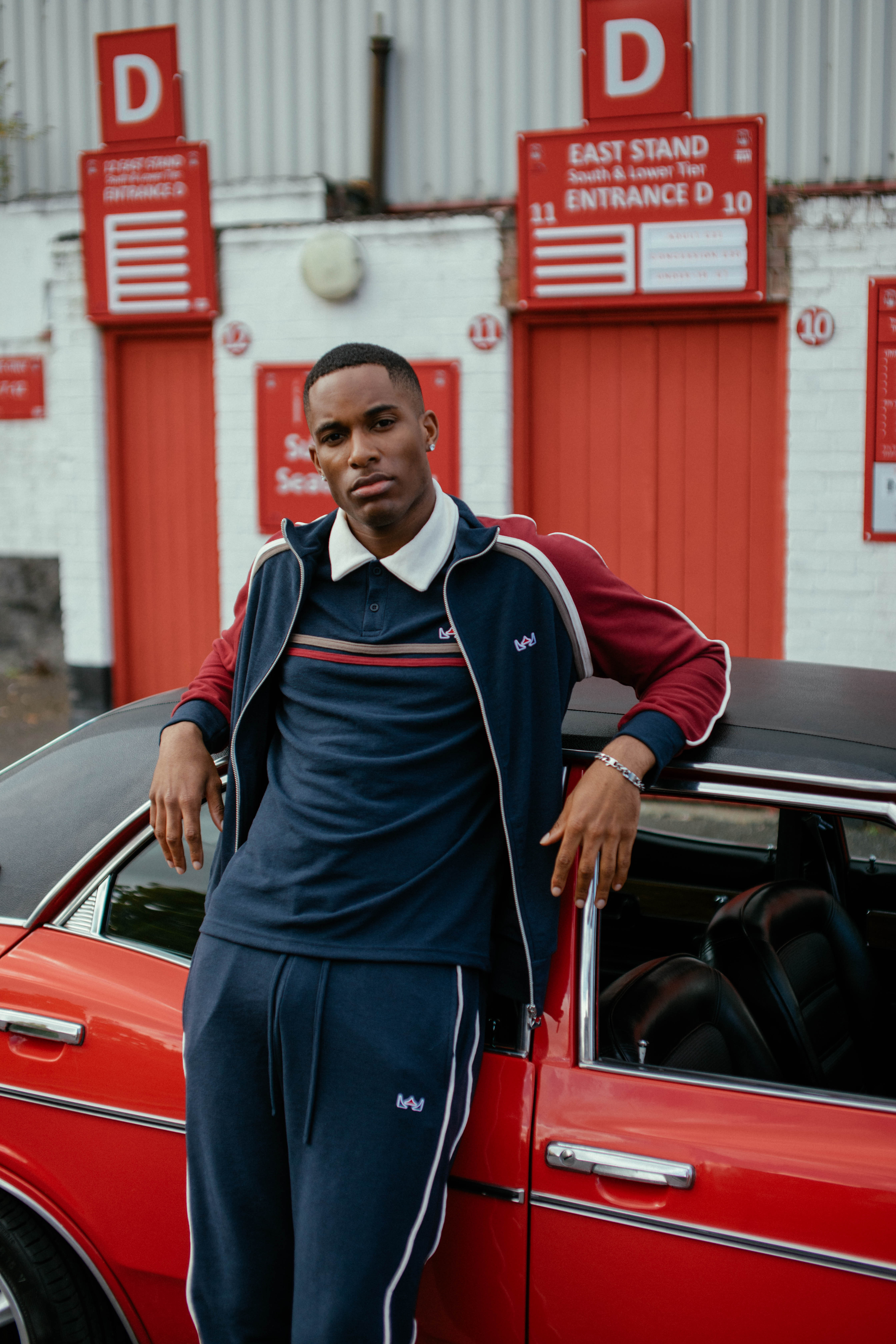 Man beside a red car