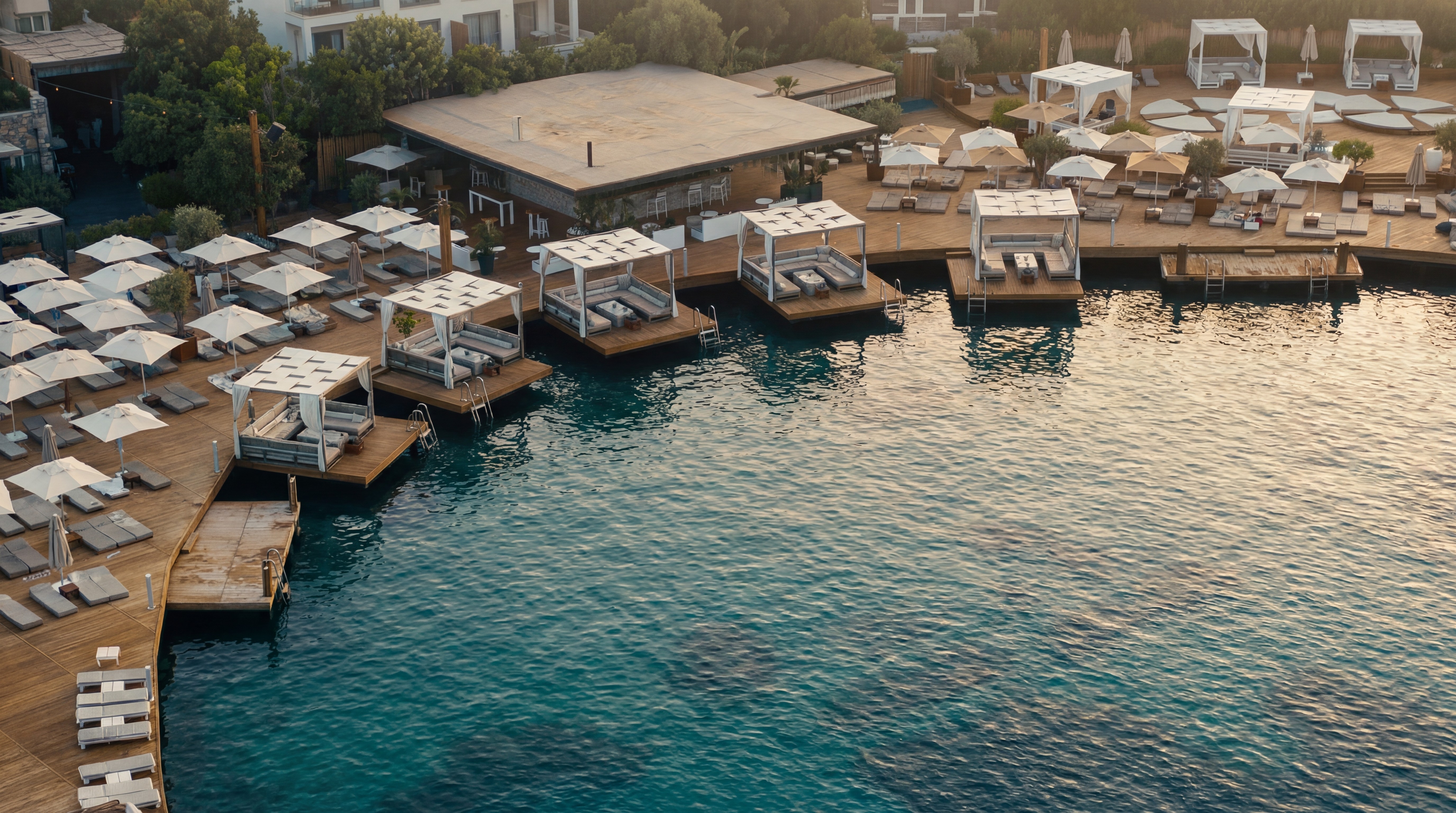 Kuum Hotel Beach Club Göltürkbükü Bodrum with private cabanas and wooden deck by the sea