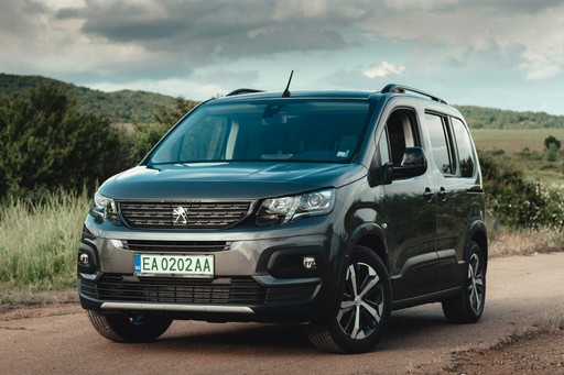 a black van is parked on a dirt road illustrating the car registration in France