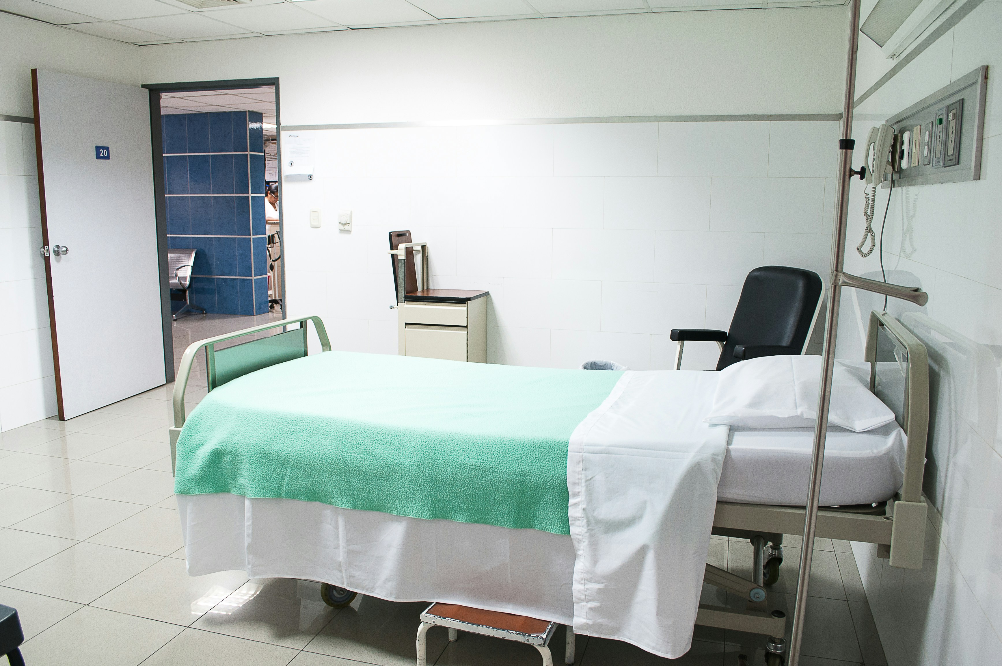 A patient lies on a table inside an MRI machine, a medical professional stands in the background.